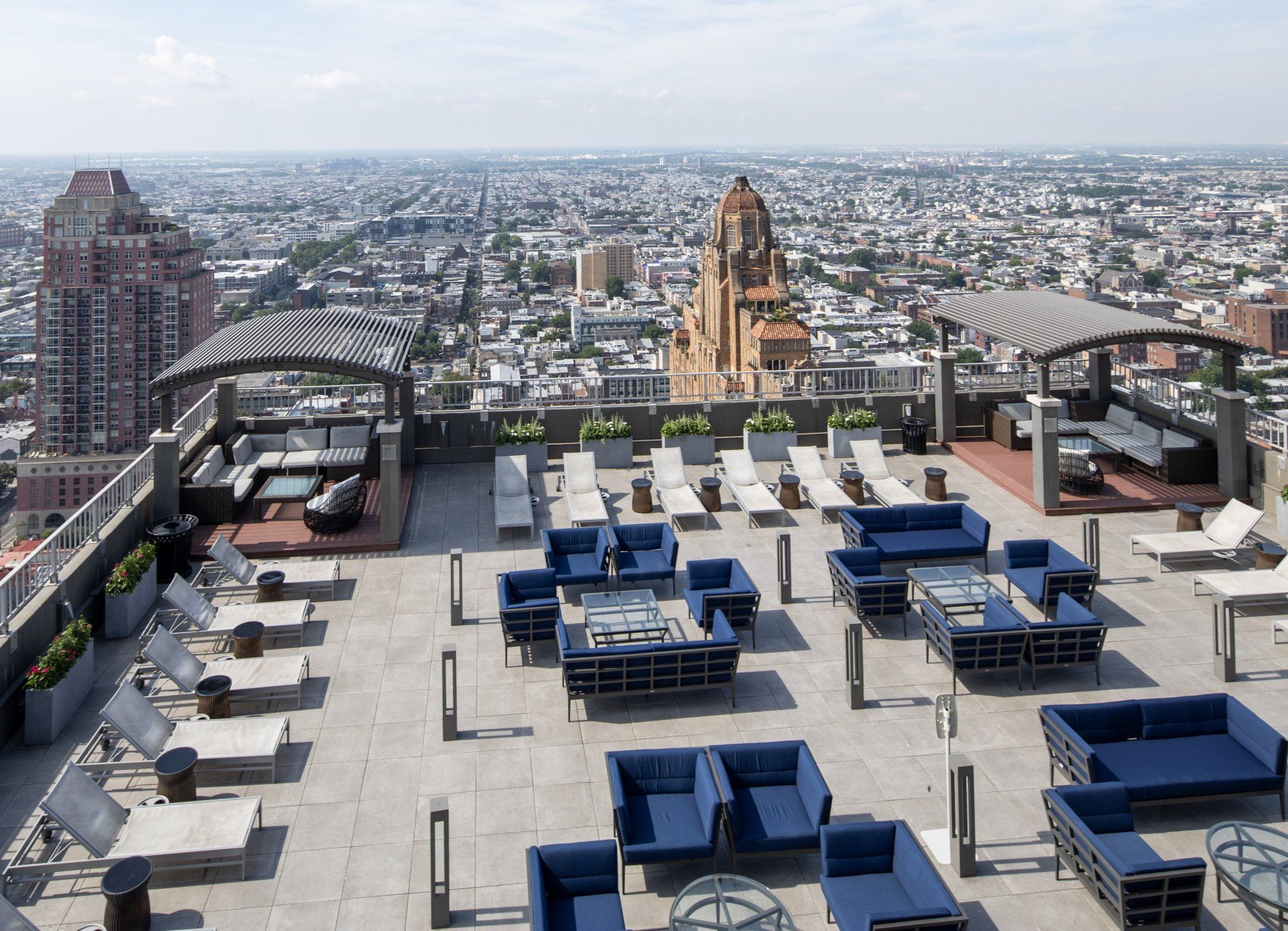 A rooftop patio with a view of the city