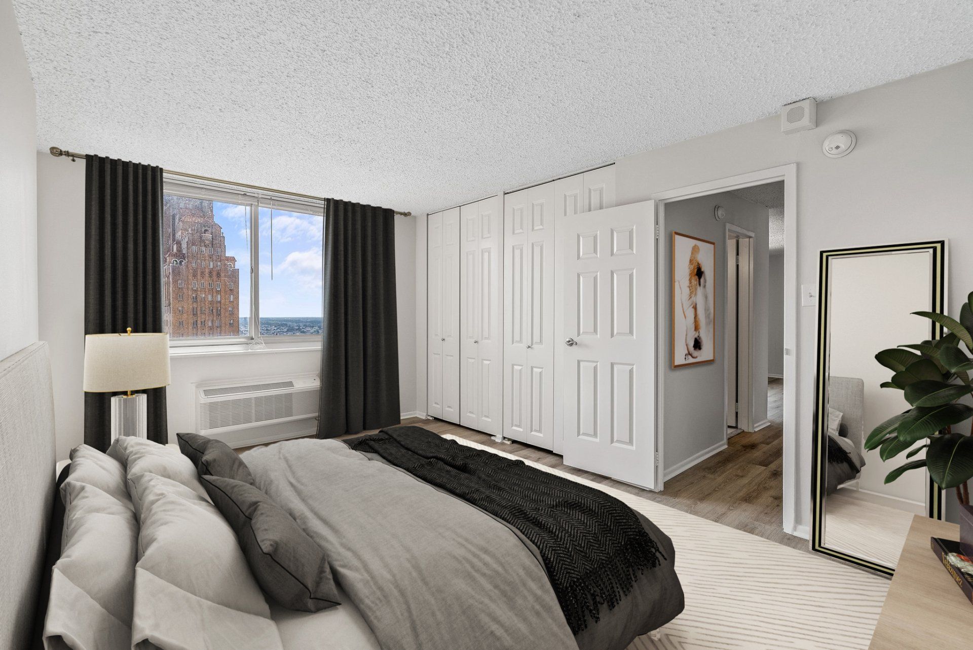 A bedroom with a large bed and a large window.