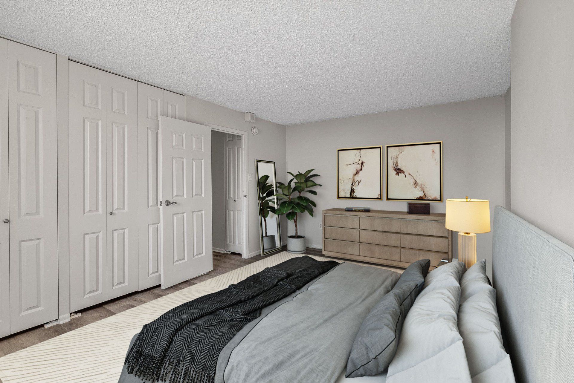 A bedroom with a large bed , dresser , and closet.