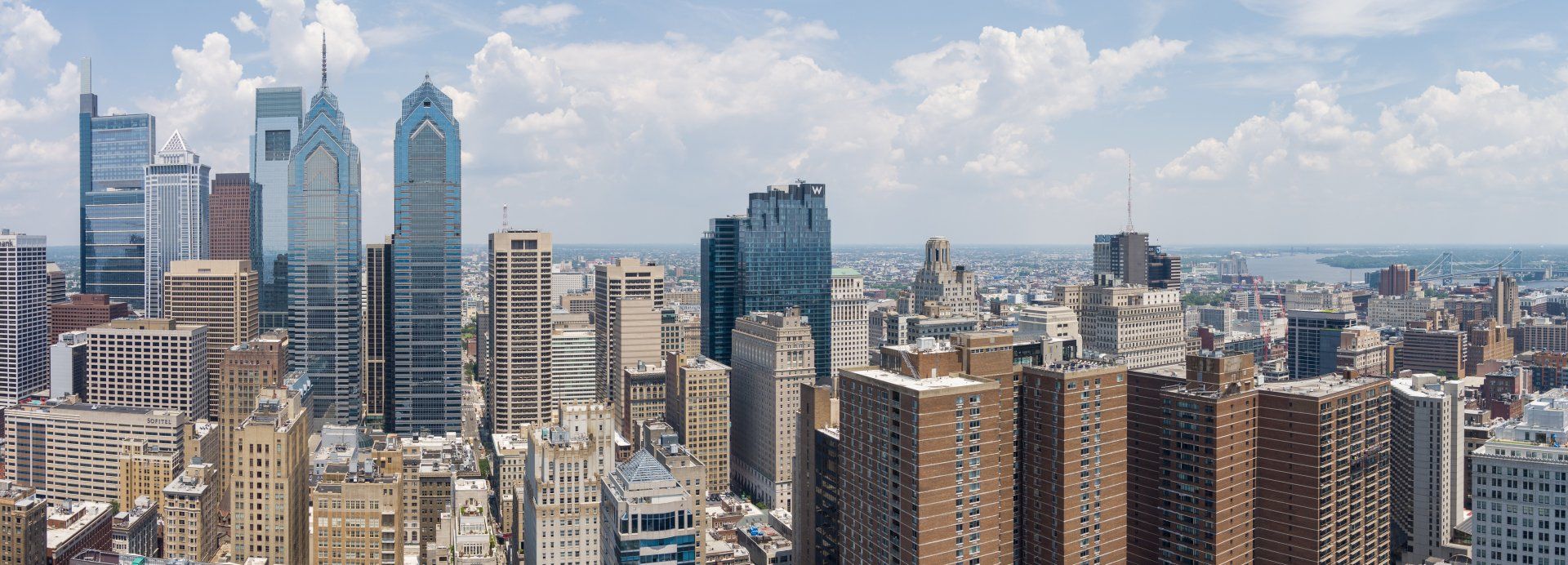 An aerial view of a city skyline on a sunny day