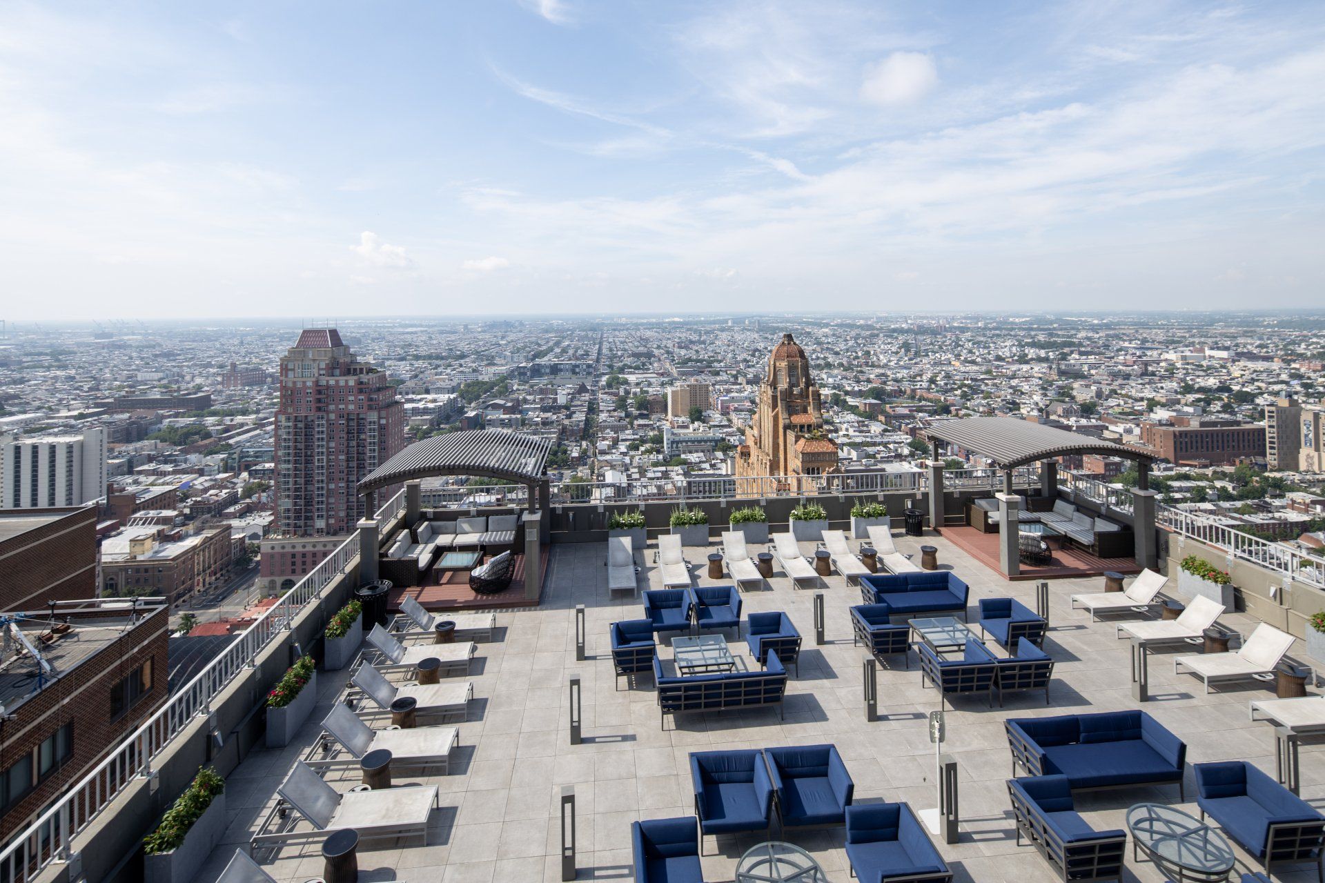 An aerial view of a rooftop patio with a city in the background.