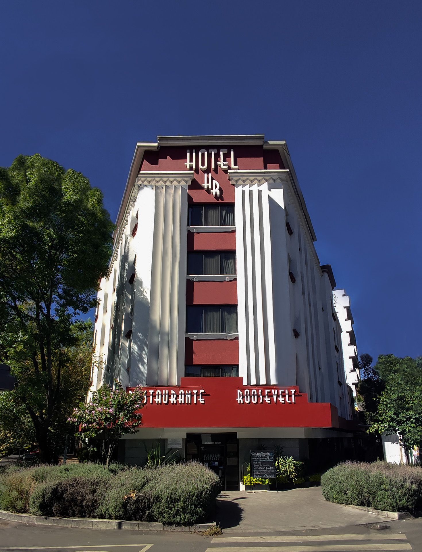 A large red and white building with the word hotel on it