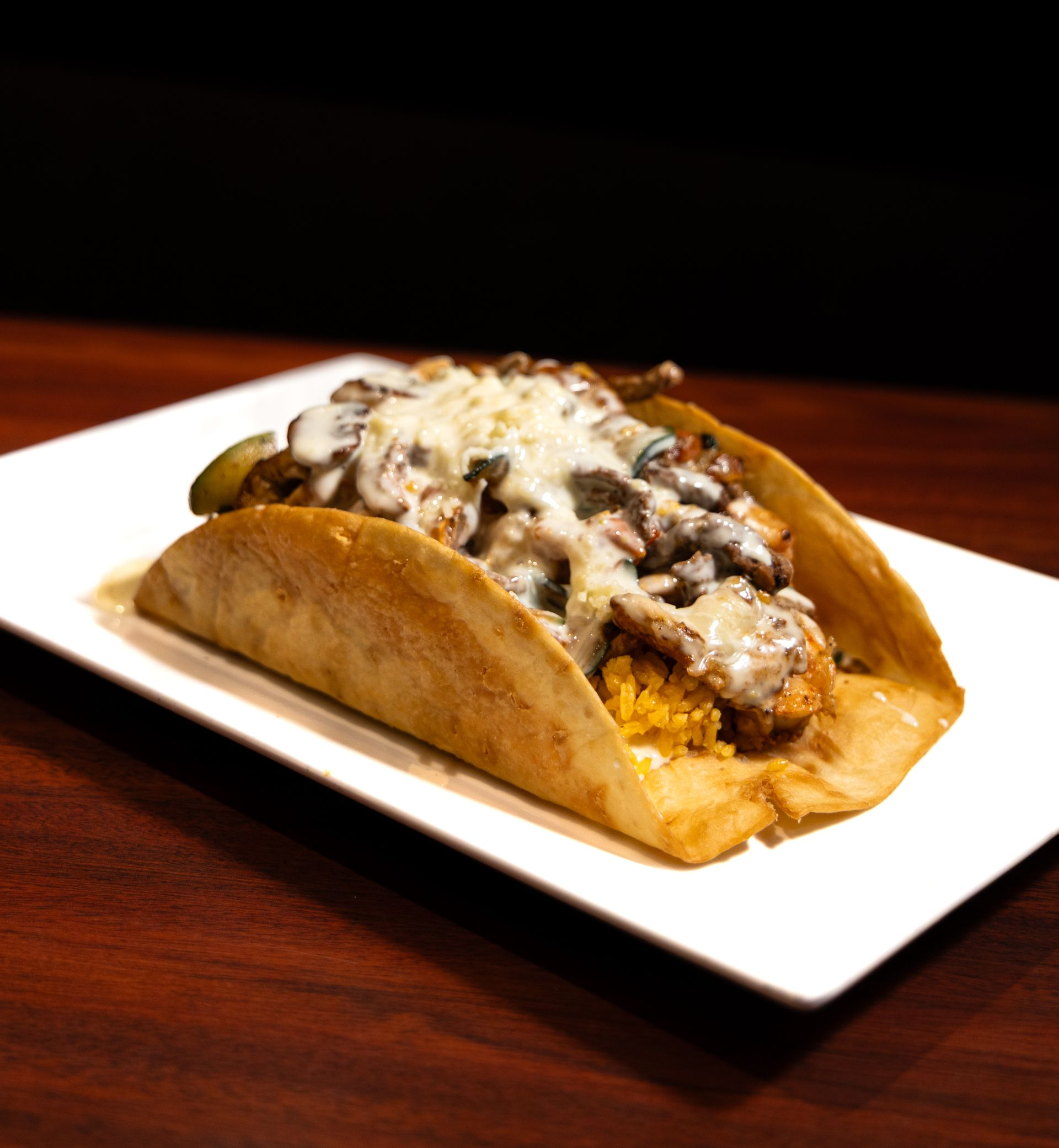 Plate of braised meat with rice and beans, Don Ramon logo.