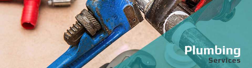 A blue pipe wrench and other tools rest on a surface, next to the text 
