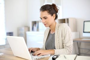Woman Using Her Laptop — Ames, IA — Howell Investment Finance