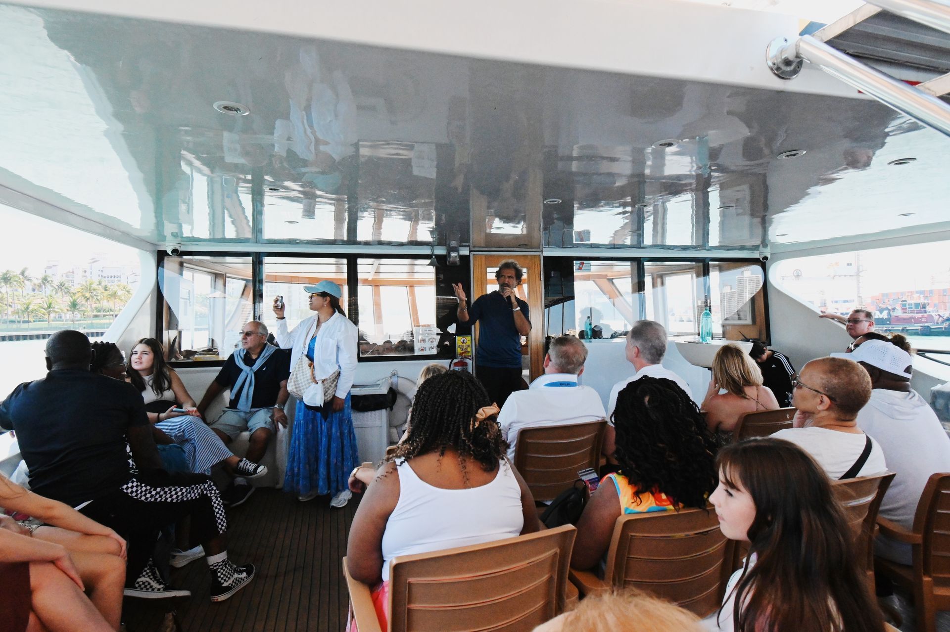 Tour Guide and passengers on the top deck of the Miami Boat Tour