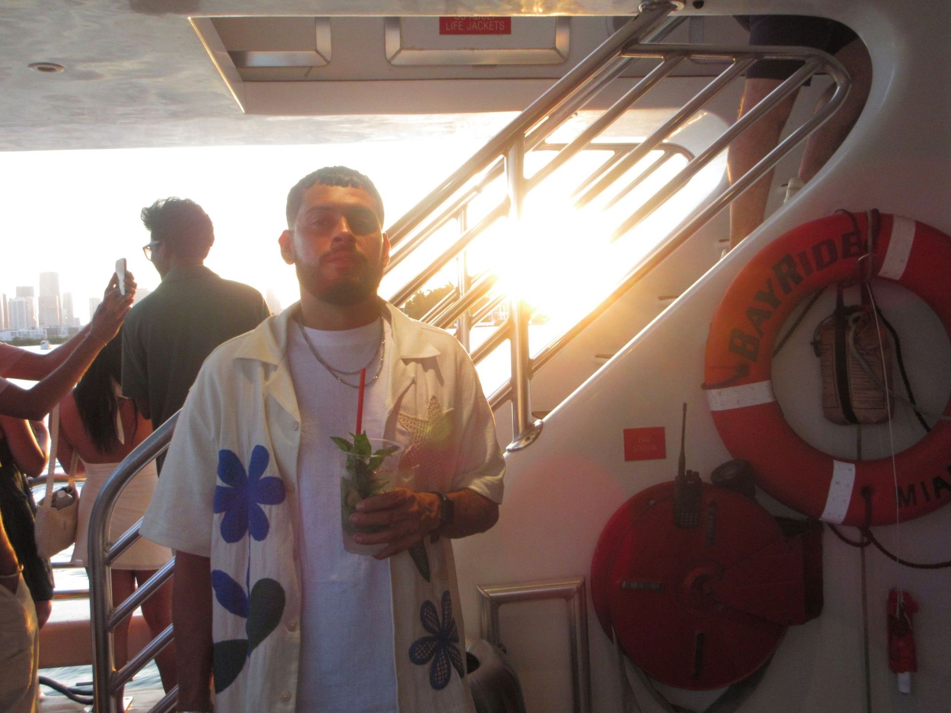 Miami man relaxing with a drink on the Miami boat tour using the Miami305 promo code