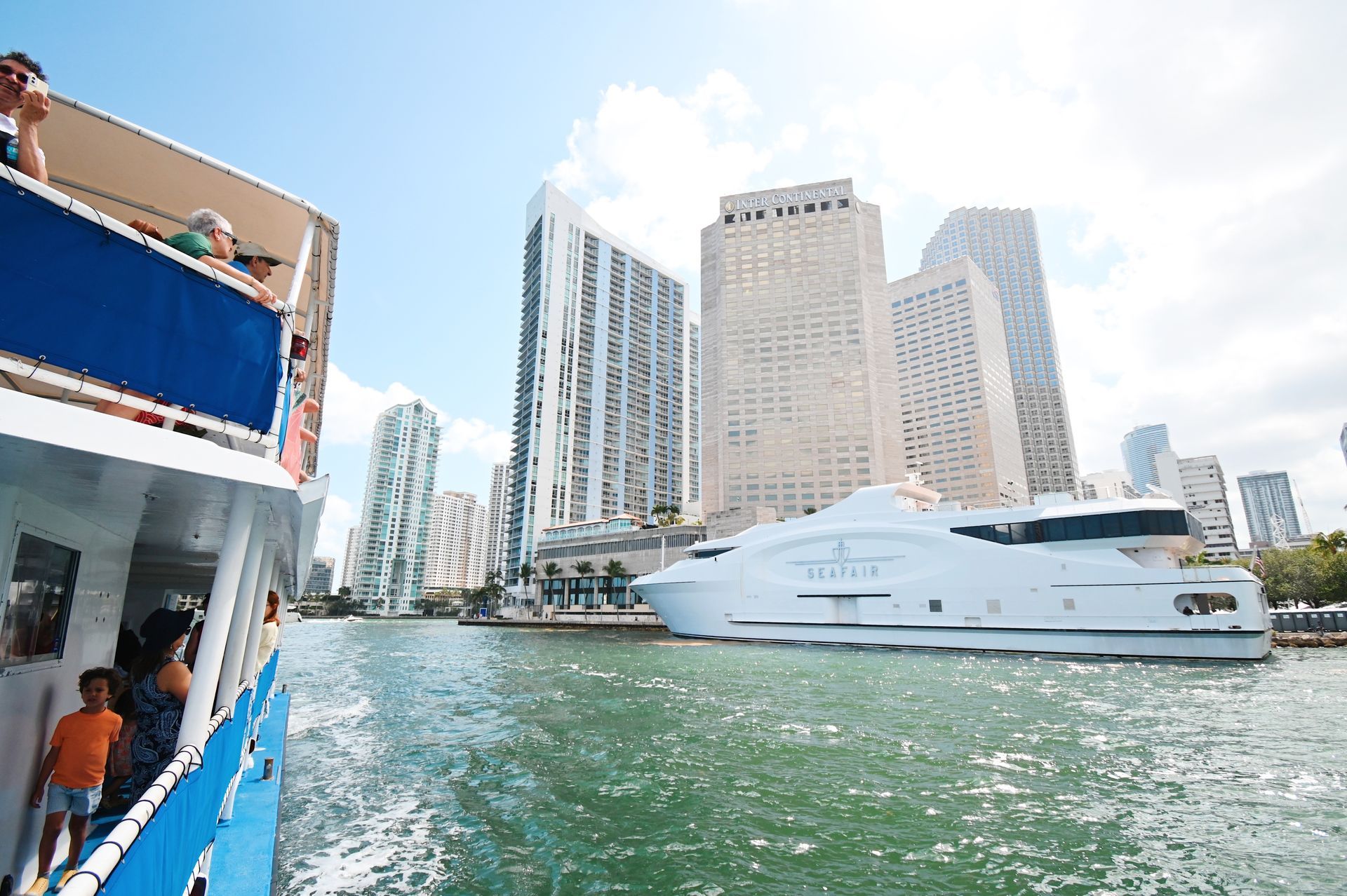 Guests enjoying the Miami Sightseeing Cruise while passing the Seafair yacht and the InterContinental Hotel on Biscayne Bay photo from the skyline reviews.