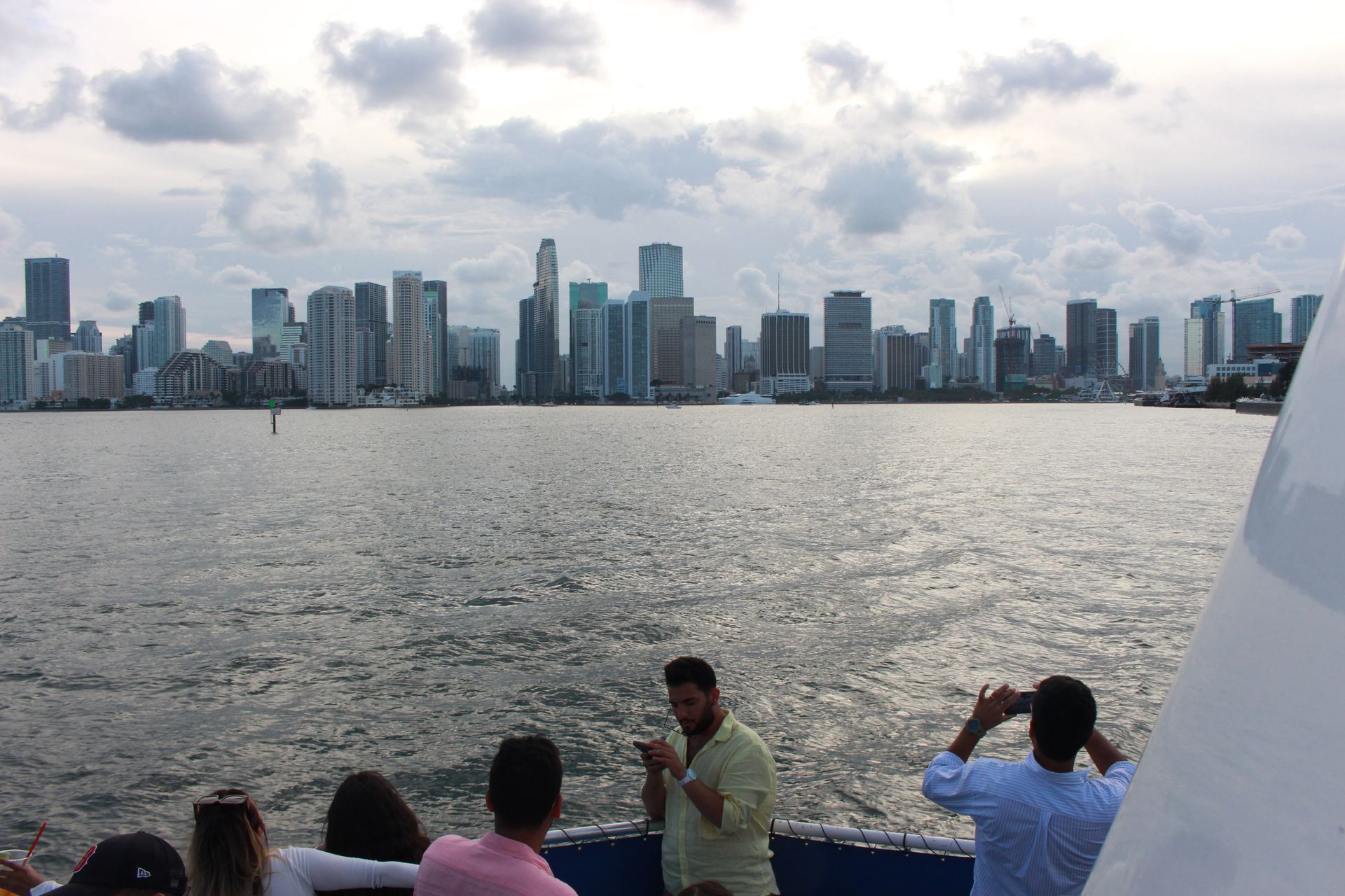 Guest in the front of the Miami Boat tour with the Miami Skyline in front of them