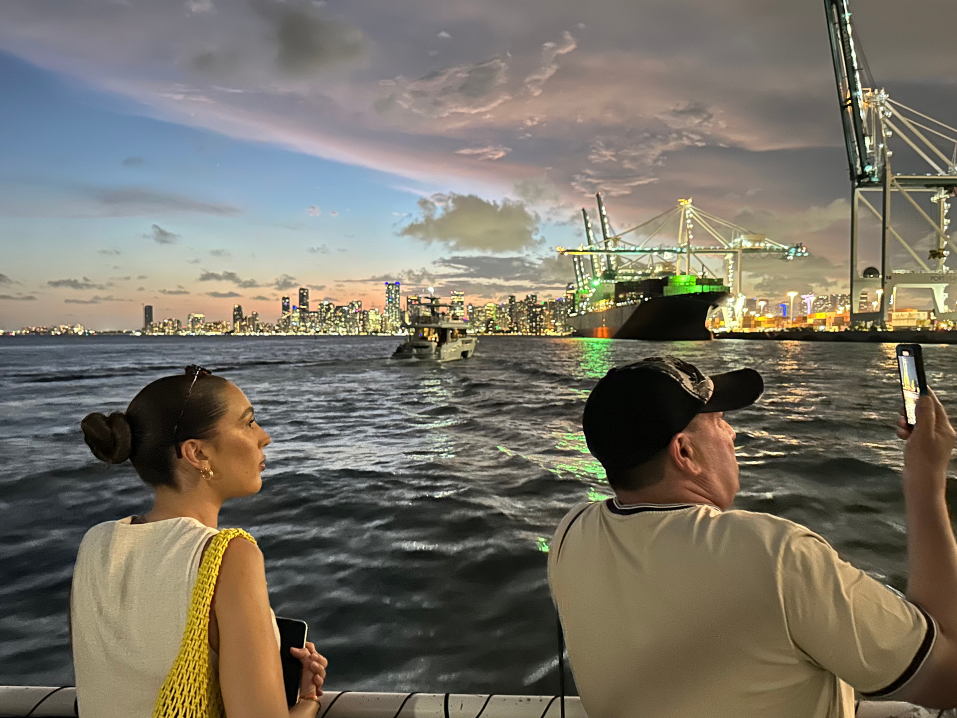 Guests enjoying the Miami skyline lit up at night near PortMiami β one of the stunning moments highlighted in Reviews.