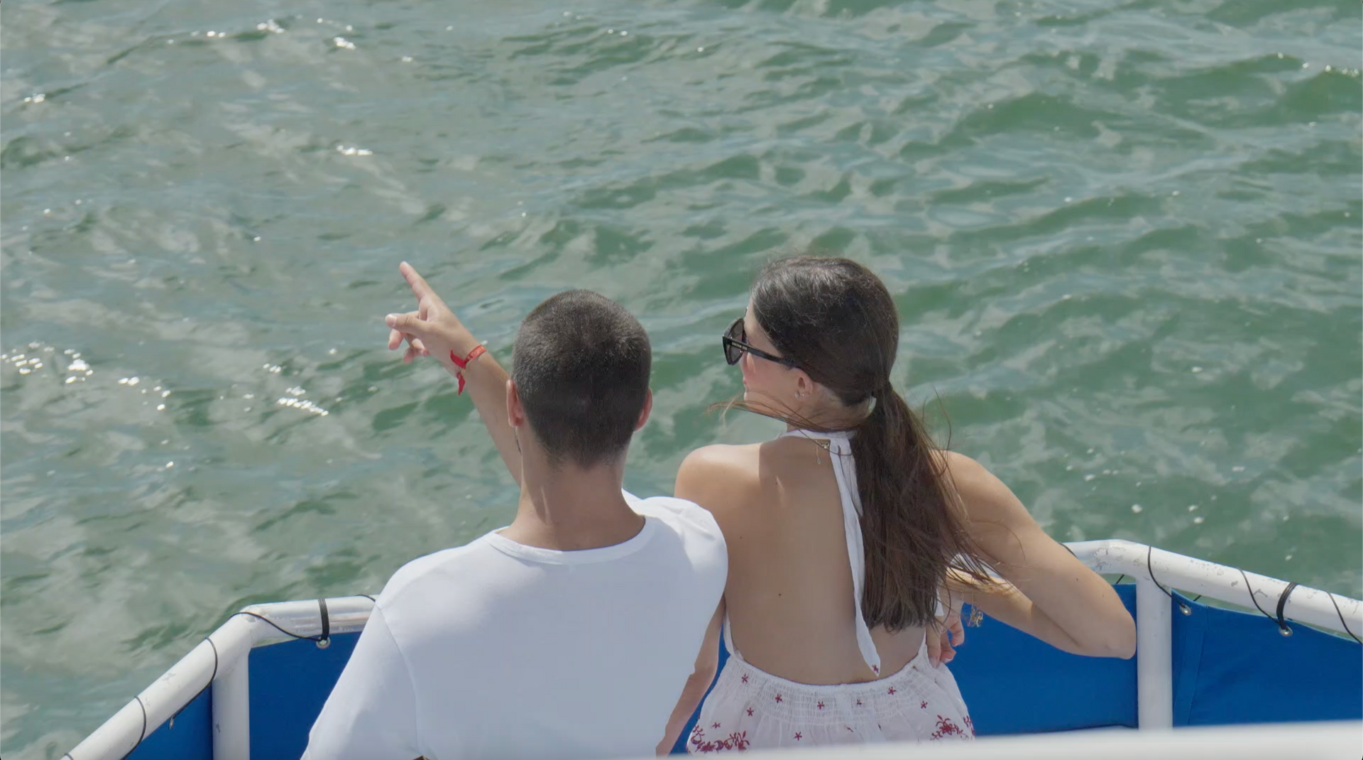 Couple standing at the front of the vessel enjoying skyline and mansion views on a Miami boat tour