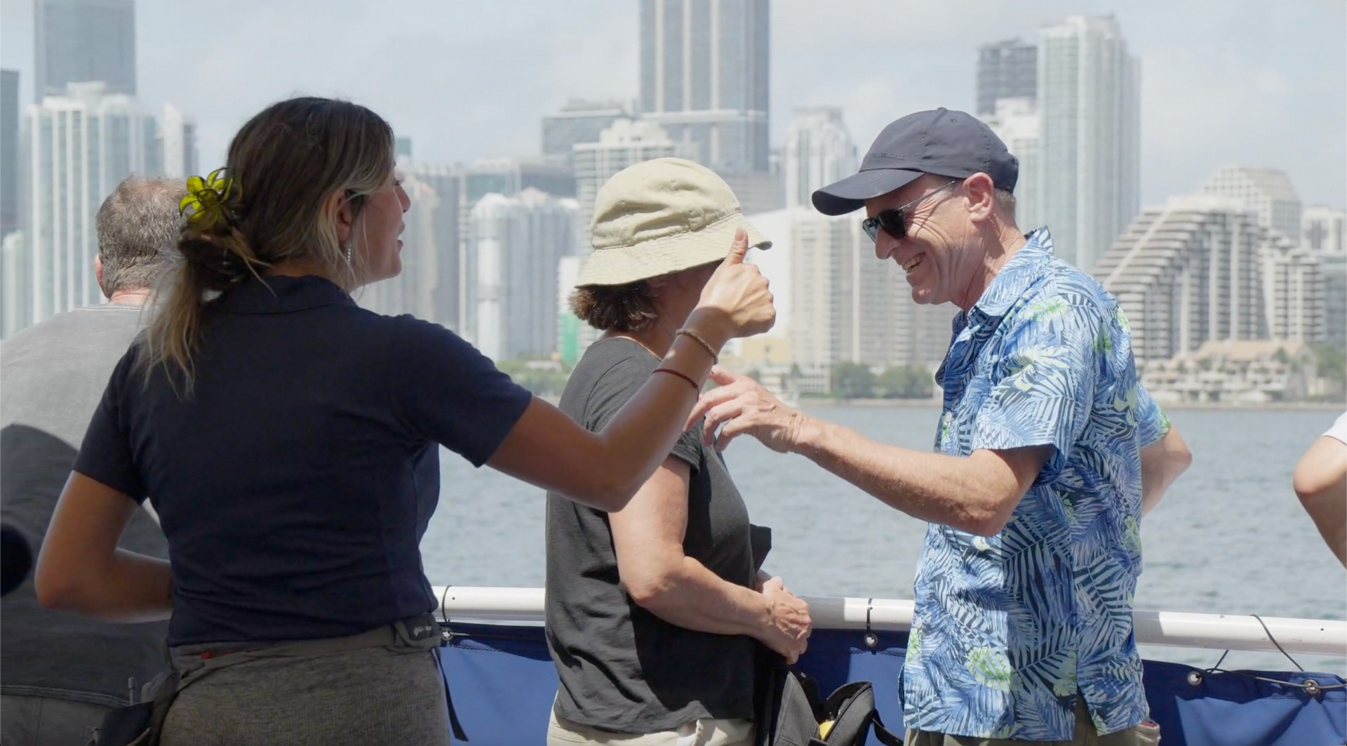 Tour guide of the Miami Skyline Celebrity Mansion Cruise talking to passengers