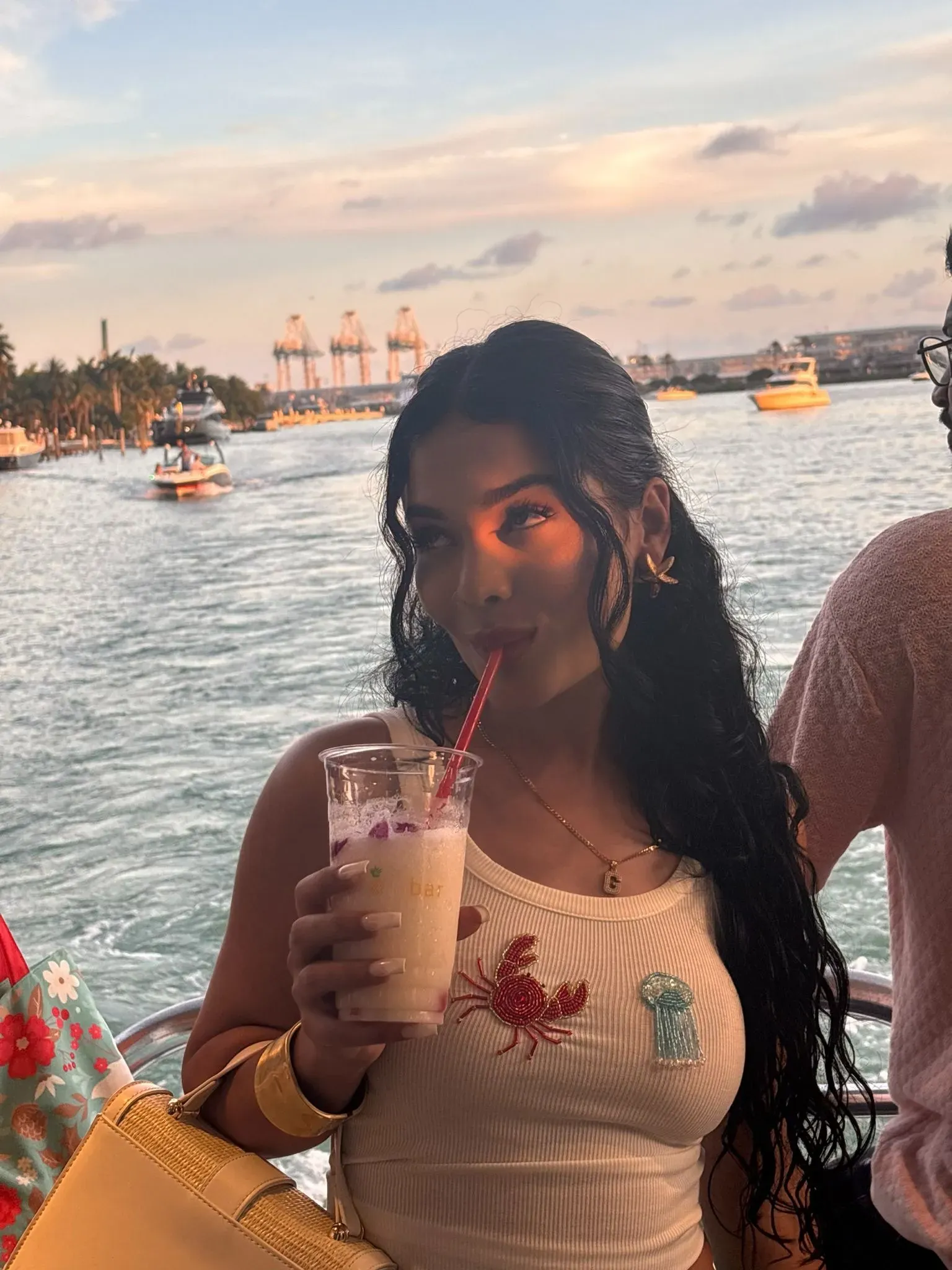 Guest enjoying a frozen drink during a Miami Sunset Cruise departing from 401 Biscayne Boulevard Miami Florida 33132