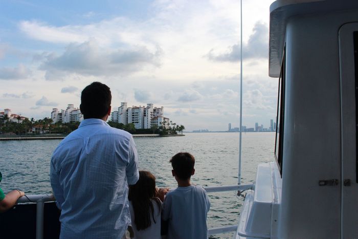 Family enjoying views of the Skyline of Fisher island in Miami