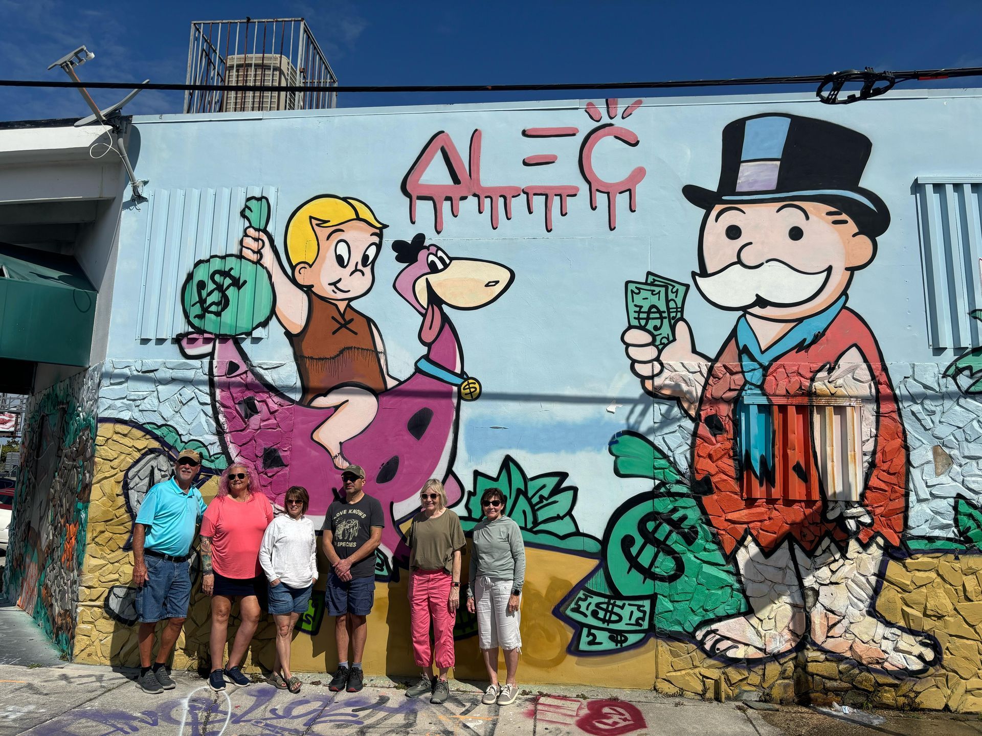 Visitors admiring and photographing the massive graffiti murals at Wynwood Walls, surrounded by Miami’s creative energy.