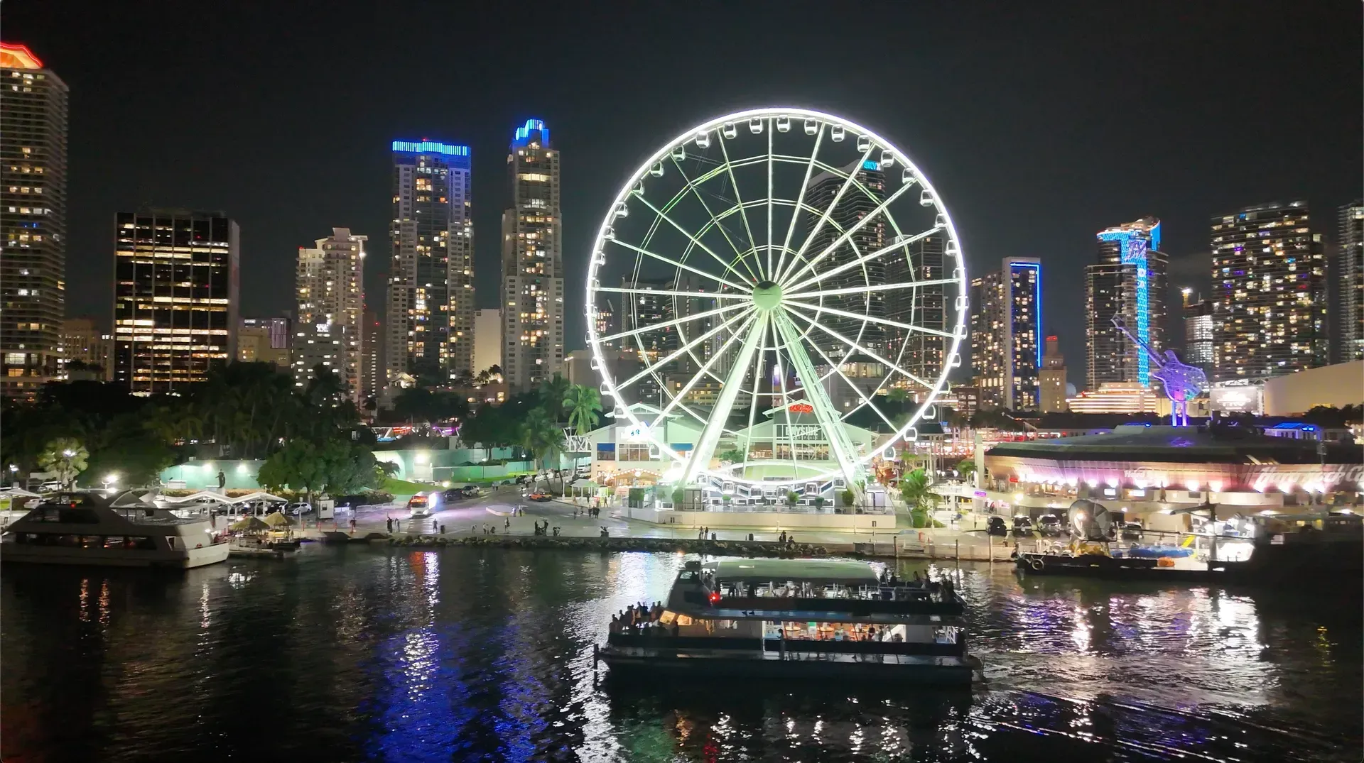 Illuminated waterfront entertainment district and city lights in Downtown Miami after dark