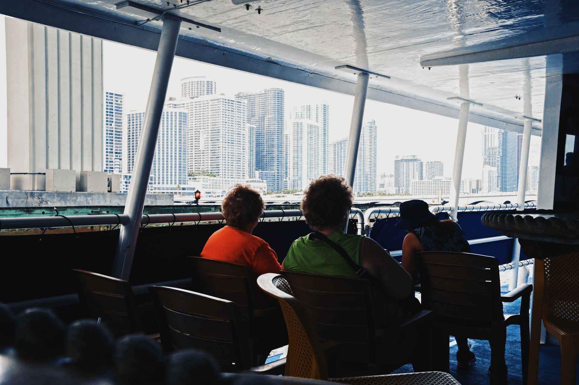 Guests relaxing on the first level of a Miami boat cruise with stunning skyline views during a sightseeing cruise in Miami