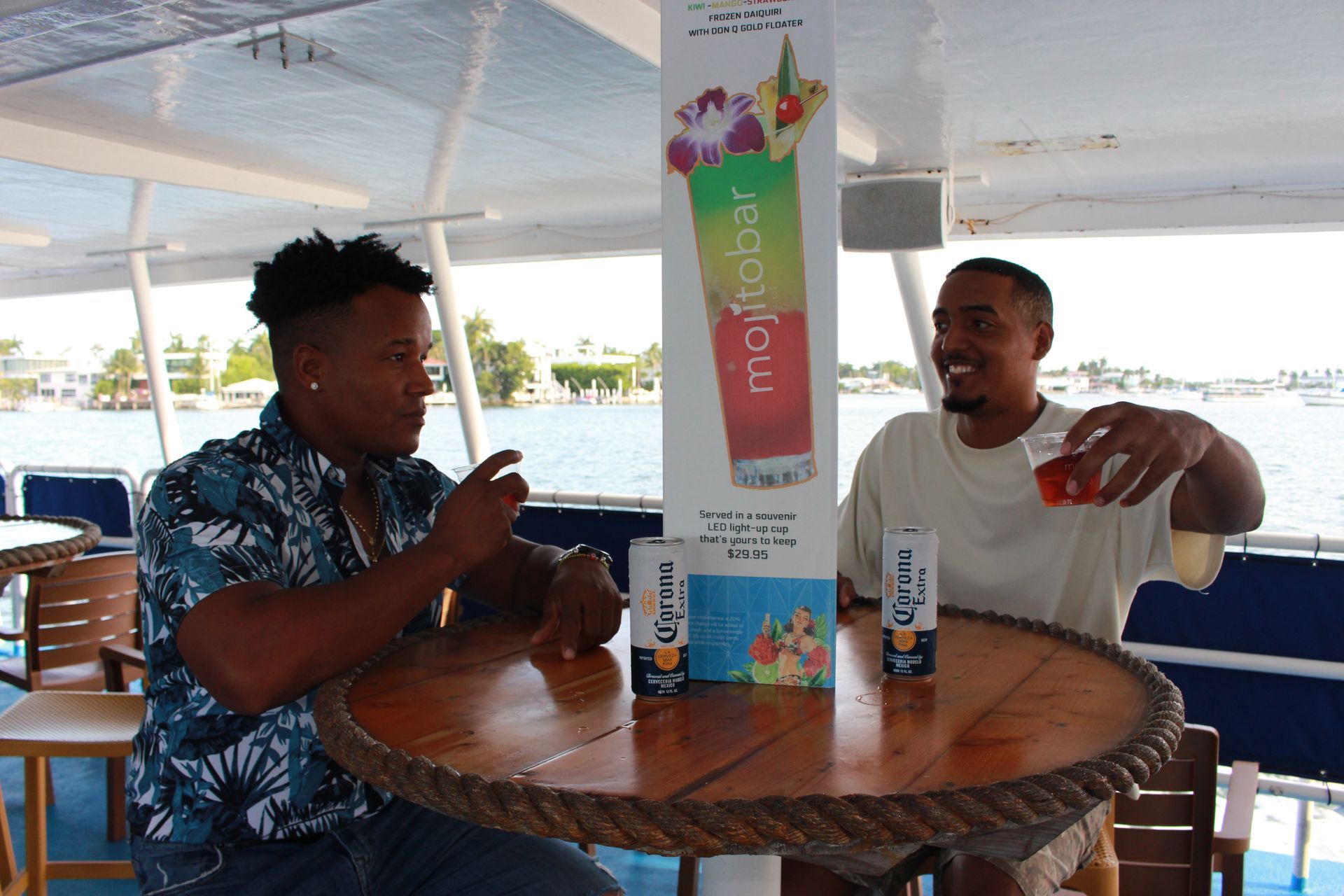 Friends enjoying craft cocktails at the Mojito Bar aboard a Biscayne Bay sightseeing cruise in Miami