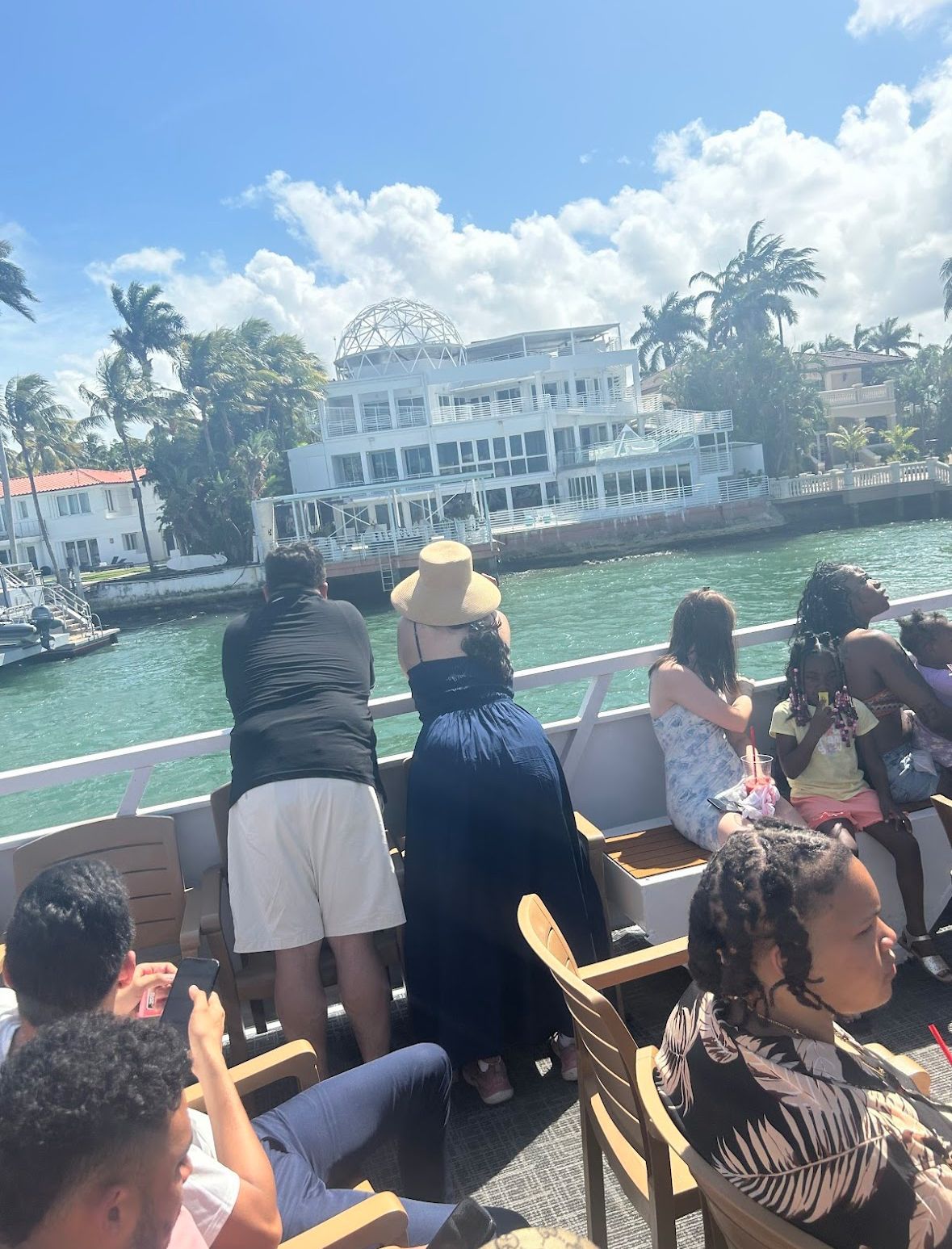Guests enjoying a Miami boat tour with views of celebrity mansions on Star Island