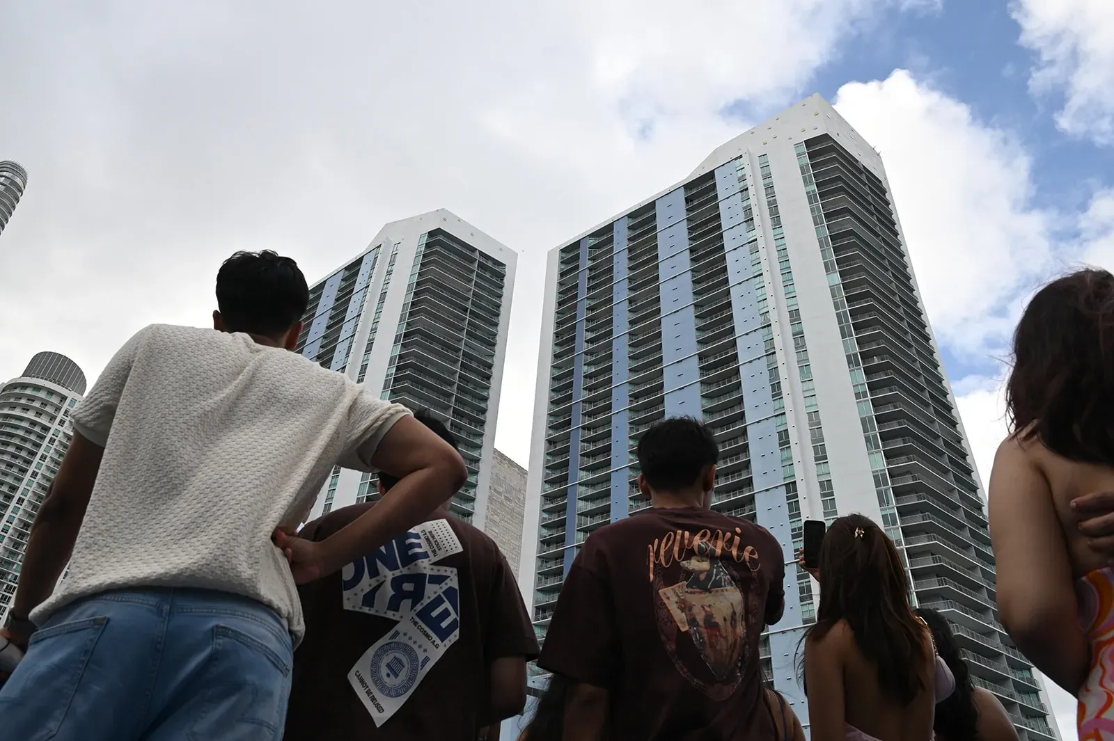 Visitors admiring modern Miami skyline architecture and high-rise residential towers in Downtown Miami.