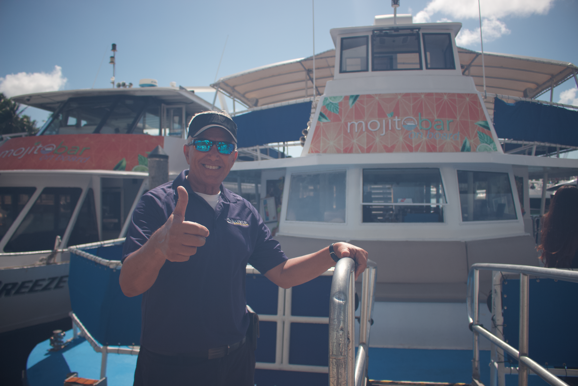 Captain greeting guests in front of Mojito Bar boat – Miami Skyline Boat Tour with 15 daily schedule trips.