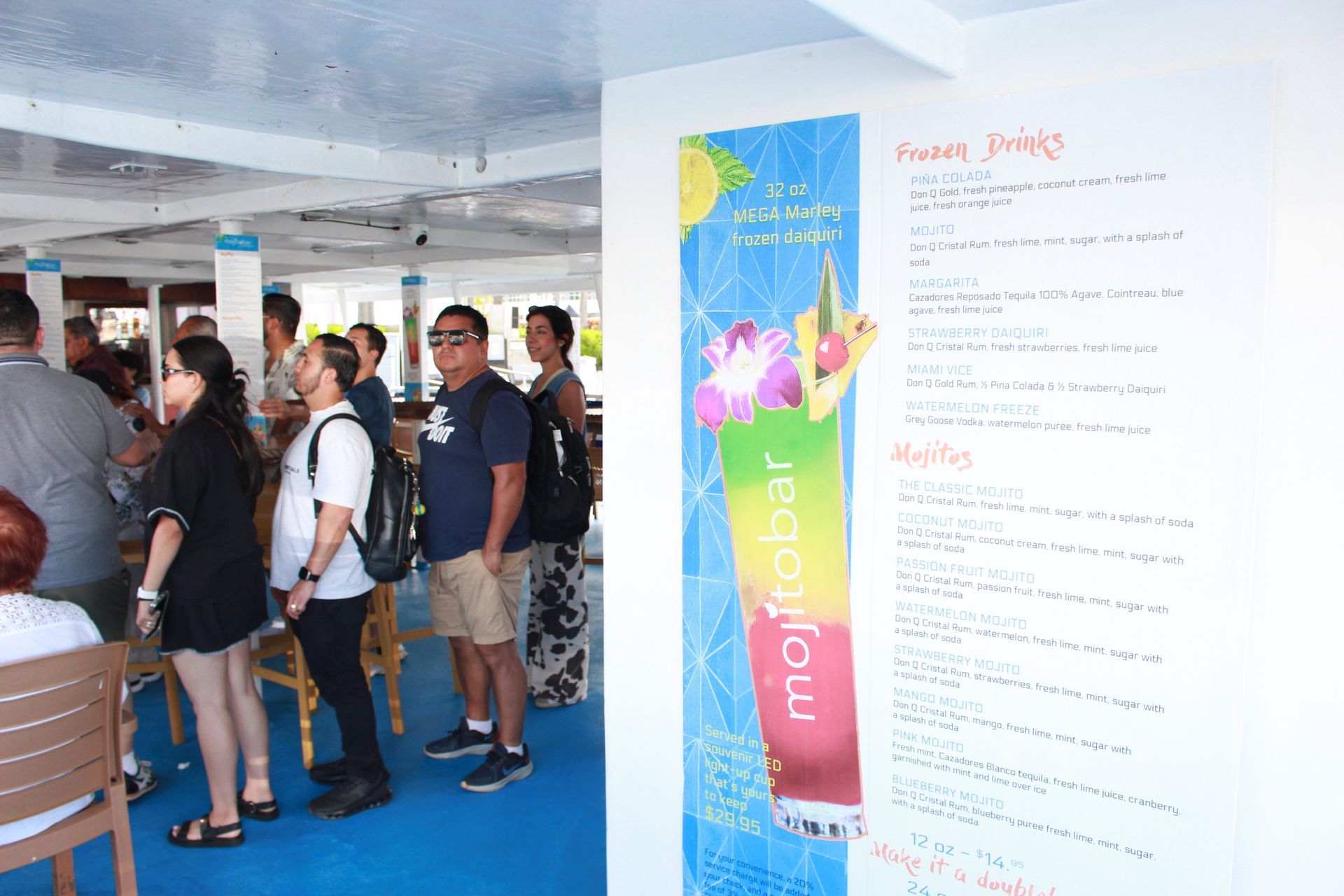 Guests lining up at Mojito Bar on Biscayne Bay cruise featuring vibrant frozen drinks and mojitos