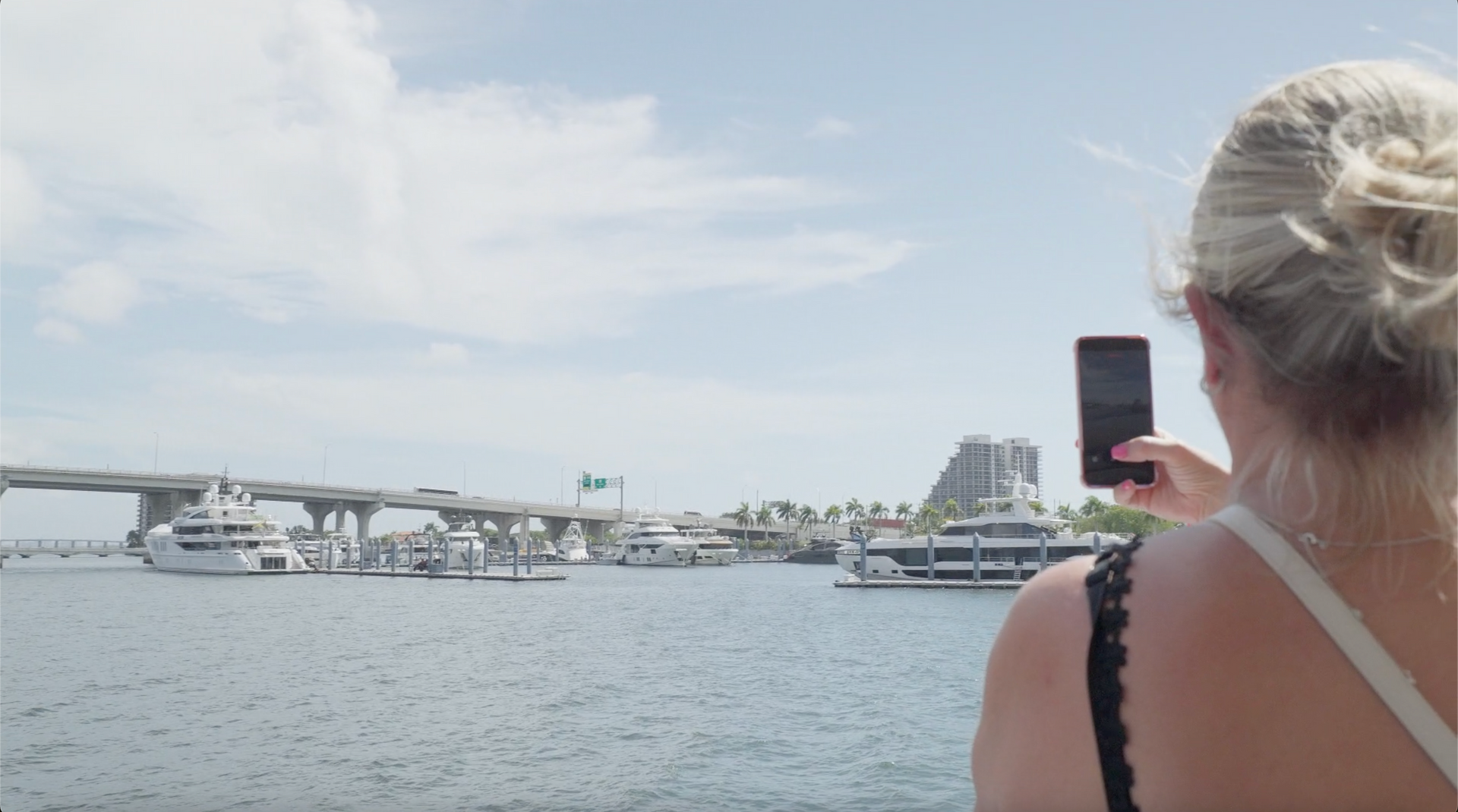 Passenger taking photos of the Miami Skyline on the Miami Boat Cruise