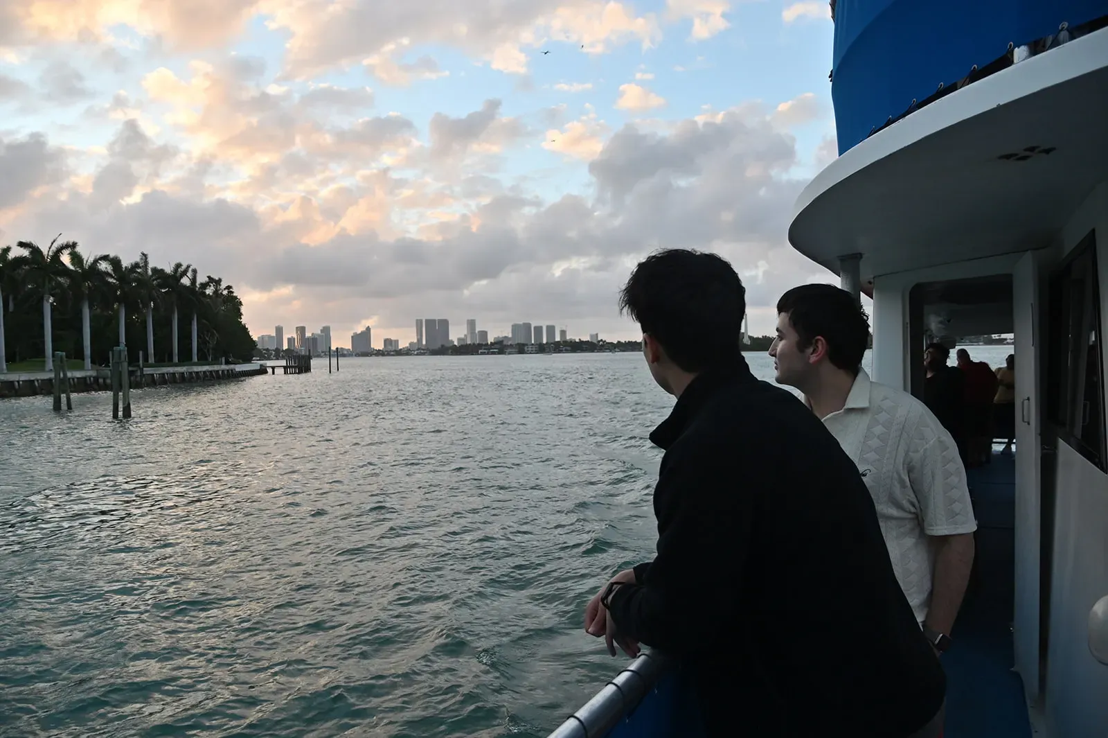 Guests enjoying a Miami skyline sunset boat tour on Biscayne Bay during golden hour in Downtown Miami