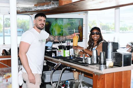 Bartender preparing drinks at the Mojito Bar onboard a Miami Skyline boat Tour, the only sightseeing boat tour in Miami with a full bar experience