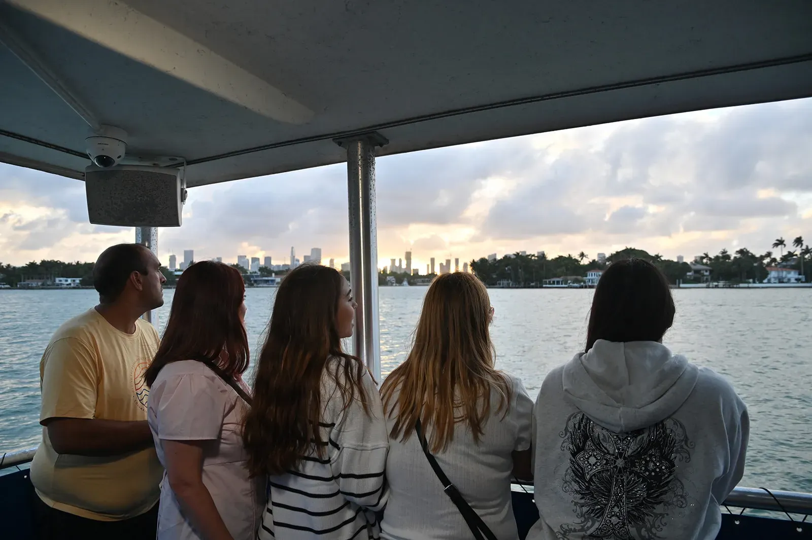 Guests enjoying a Miami Sunset Cruise with panoramic skyline views across Biscayne Bay during sunset in Miami