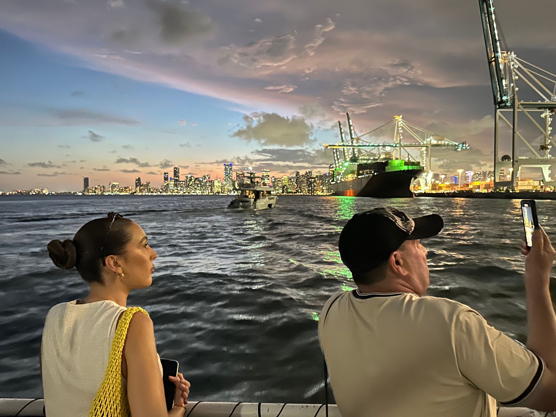 Passengers enjoying nighttime skyline views on a Miami sunset cruise.