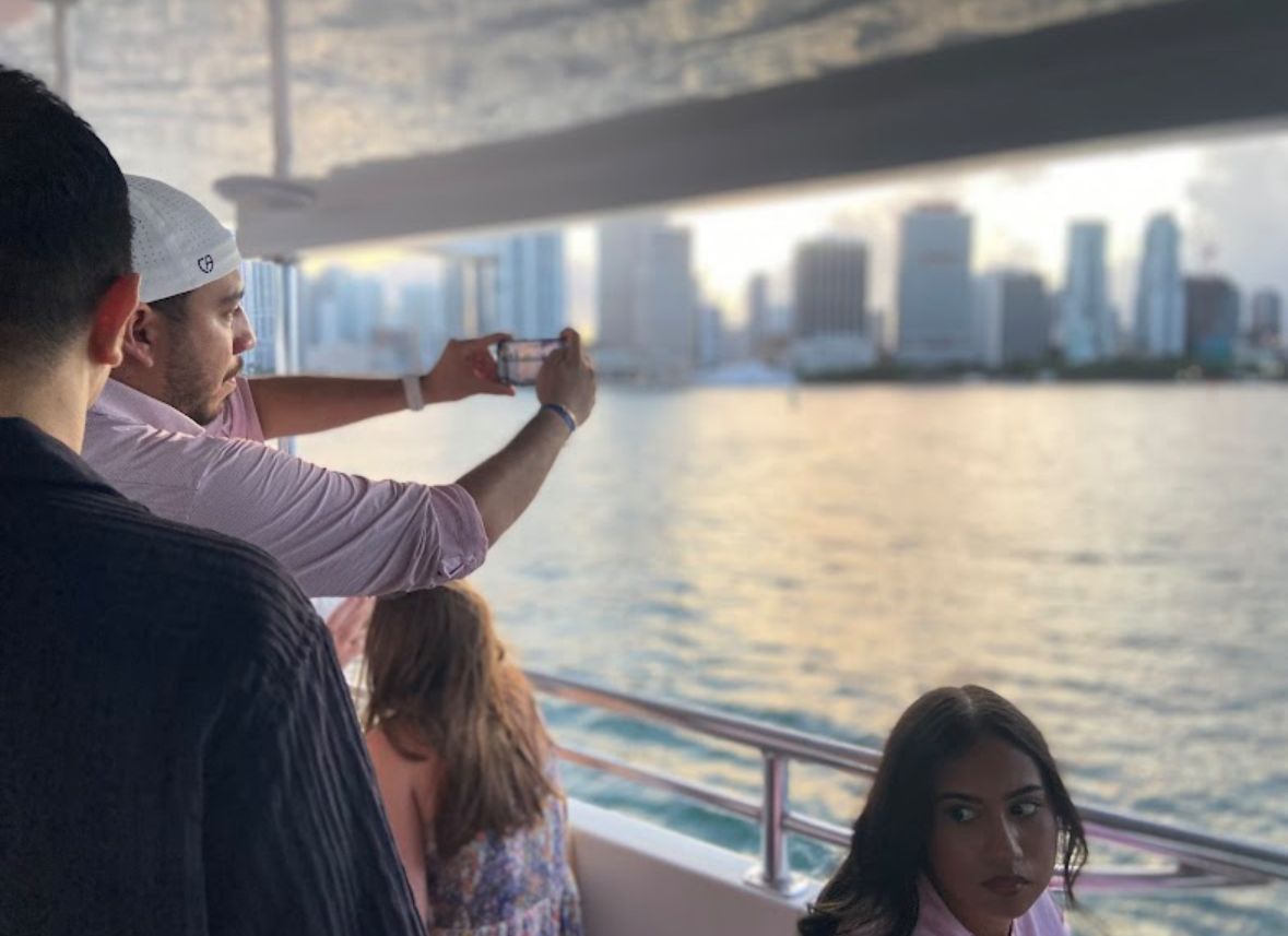 Passengers enjoying Miami skyline views during a sunset cruise.