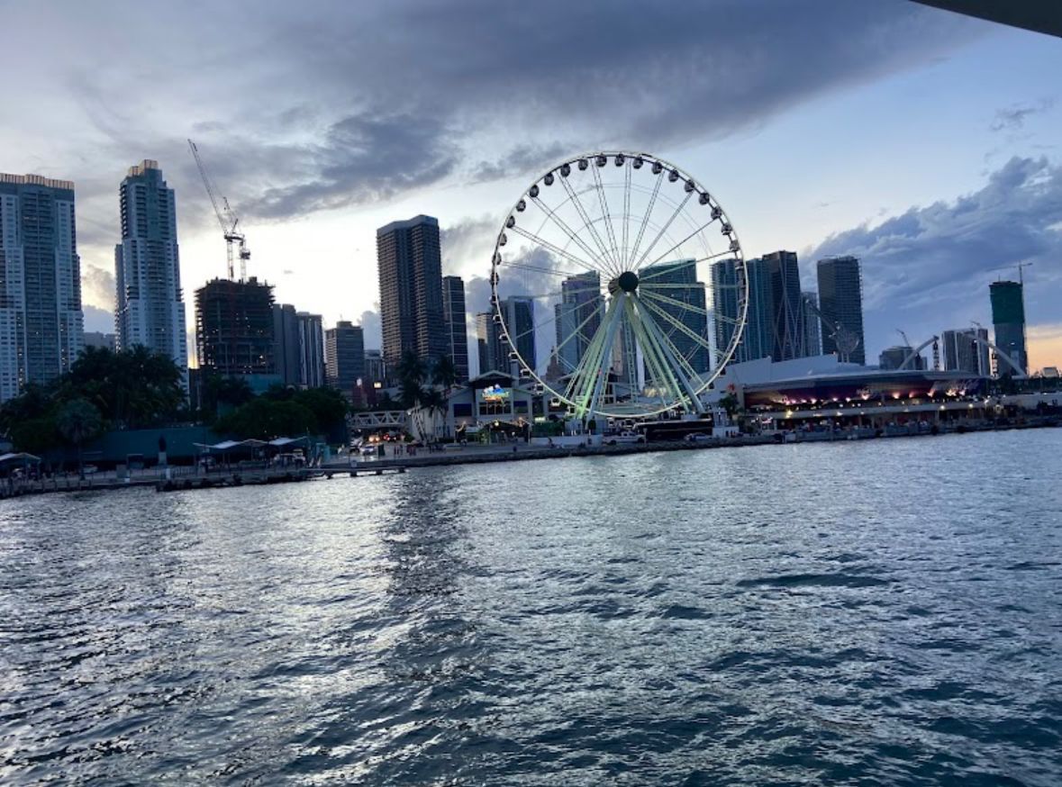 Evening boat ride past Downtown Miami’s illuminated waterfront with the Skyviews Miami Observation Wheel in full view