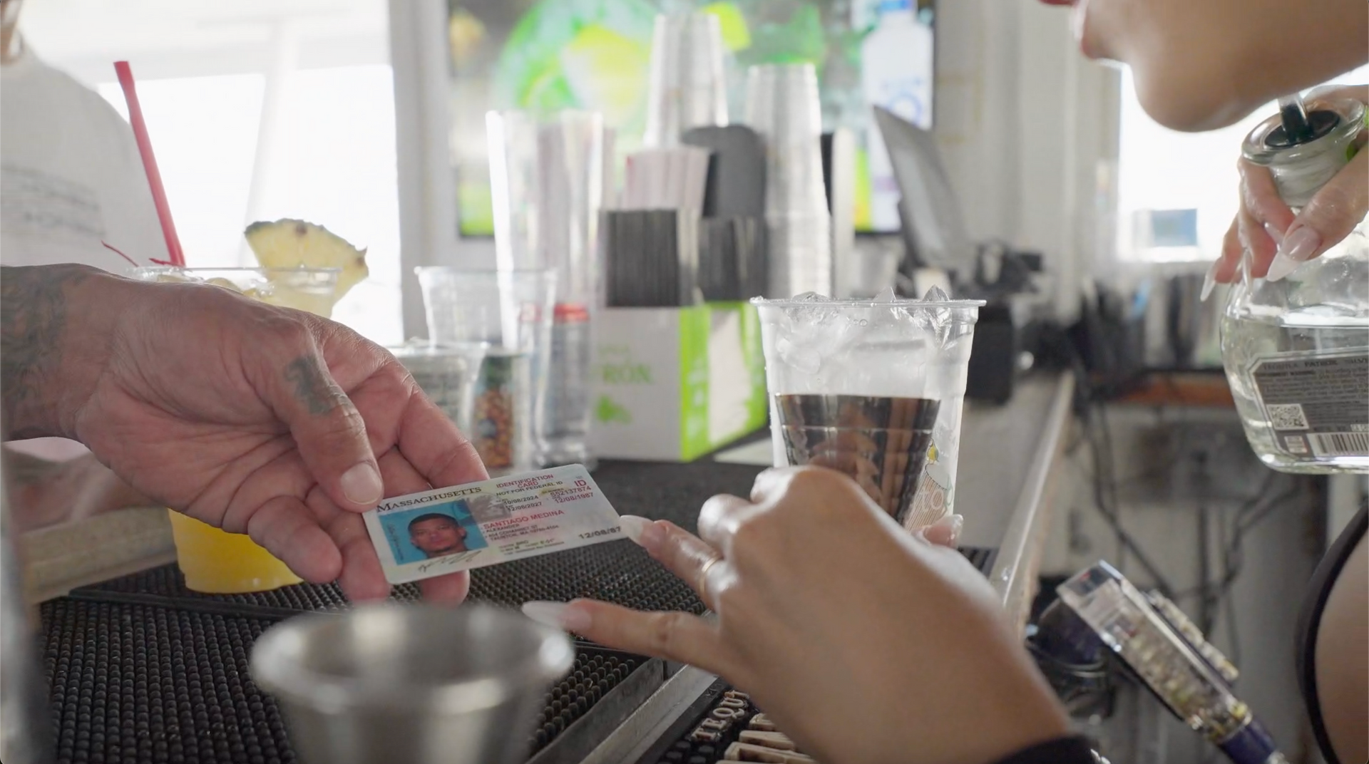 Bartender checking IDs before serving drinks on a boat cruise in Miami