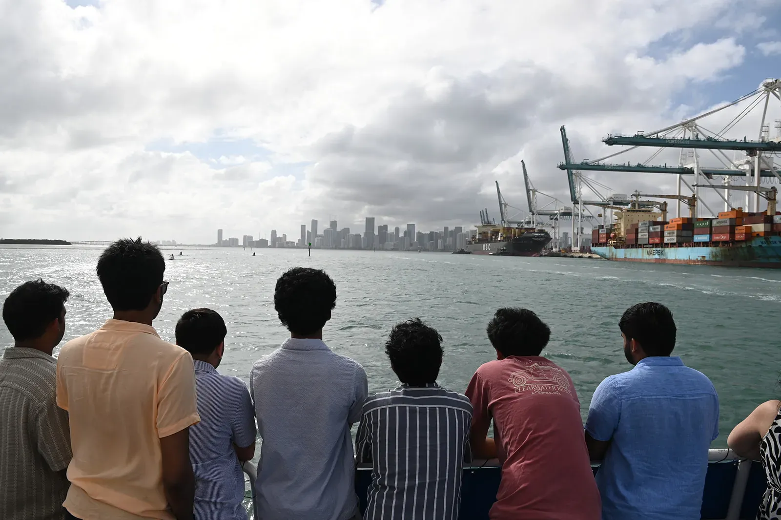 Visitors enjoying panoramic views of the skyline of Miami and PortMiami from Biscayne Bay during a sightseeing cruise.