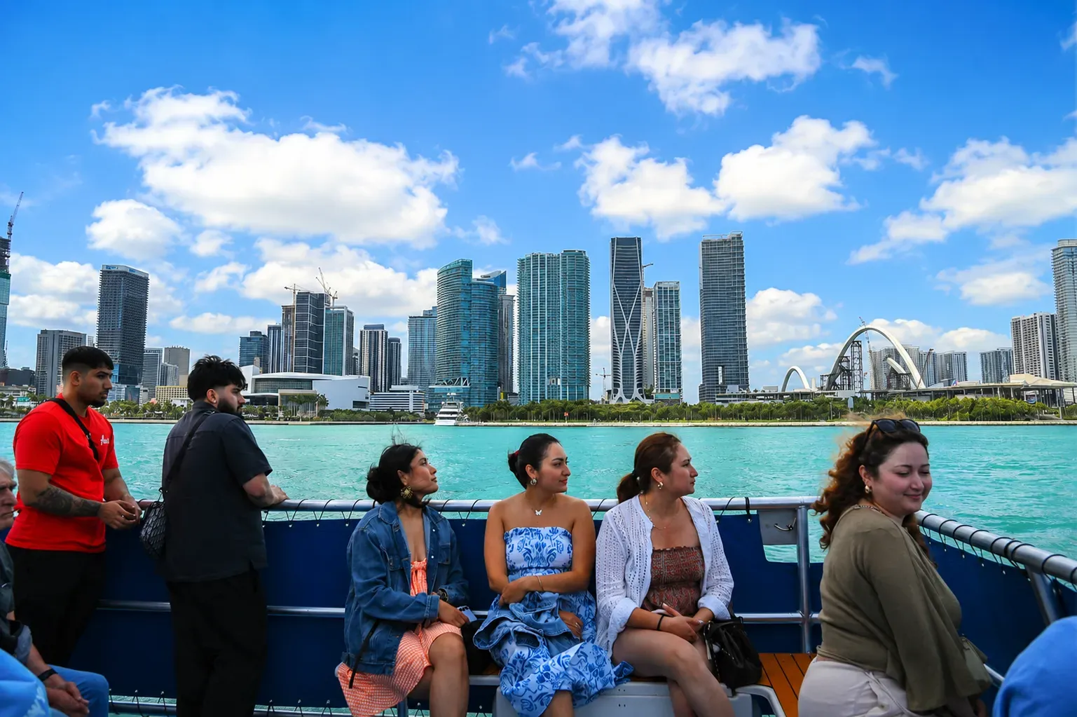 Visitors enjoying panoramic views of the skyline of Miami from Biscayne Bay, featuring Downtown Miami's waterfront and modern skyscrapers.