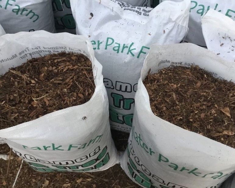 Bags of Brown Wood Mulch Are Open and Ready for Use — Gladstone Garden & Landscaping Supplies In Burua, QLD
