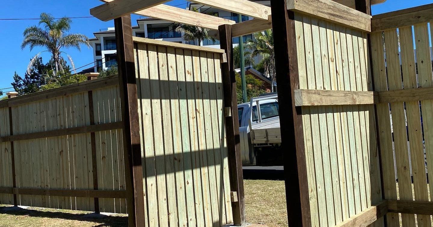 Wooden Gate in A Fence, Leading to A Yard, with Horizontal and Vertical Beams — Gladstone Garden & Landscaping Supplies In Burua, QLD