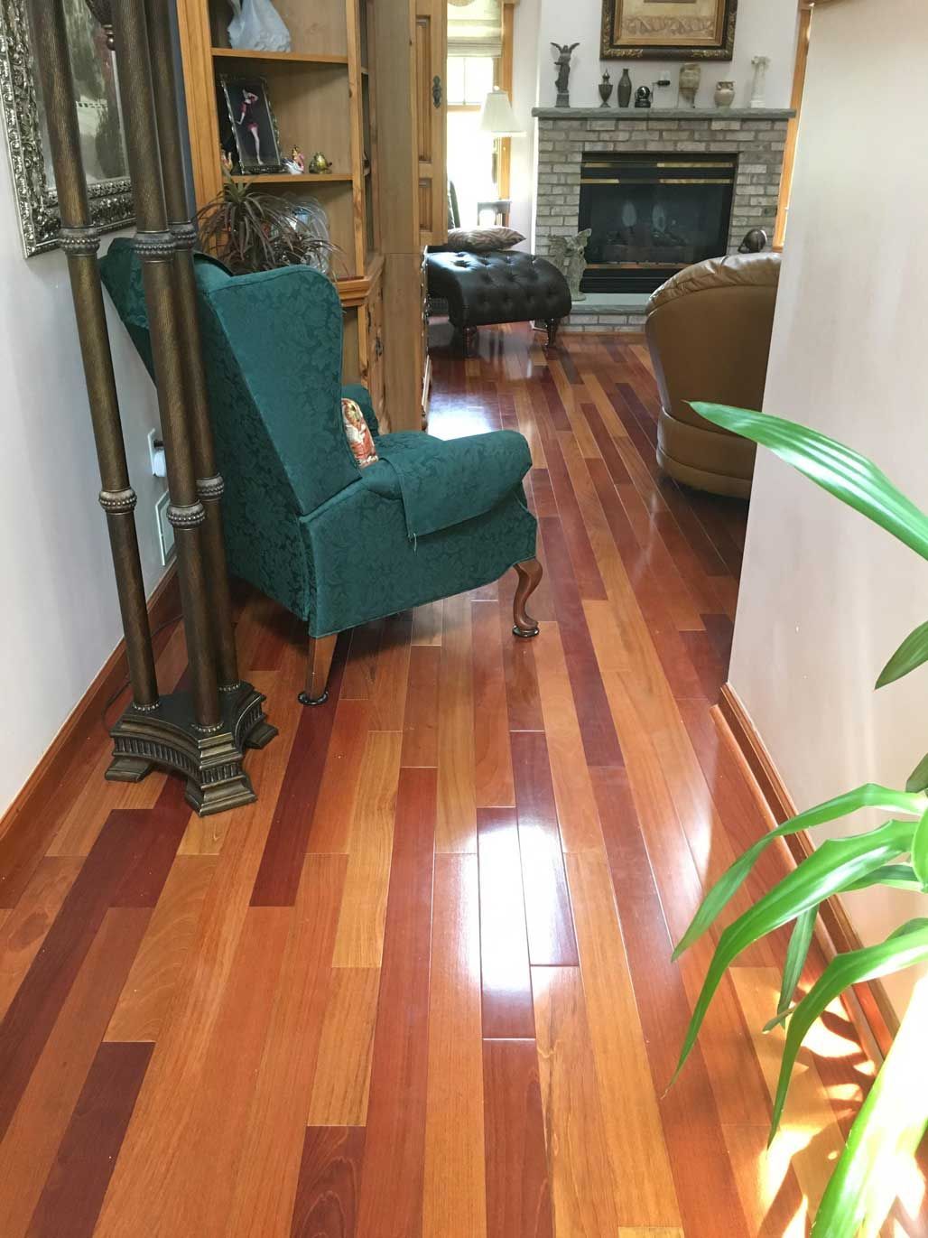 A living room with hardwood floors and a green chair