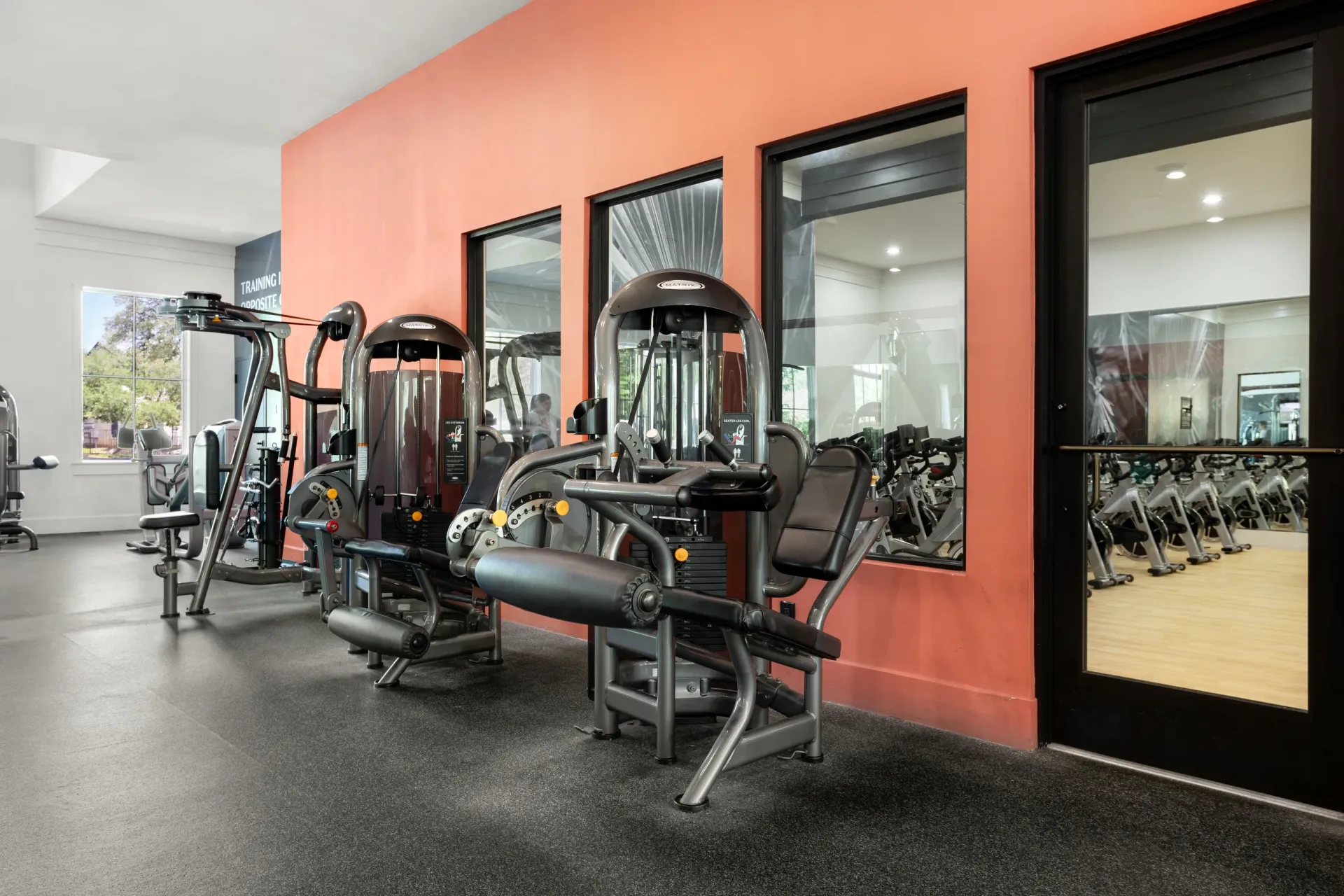 Gym with weight machines and spin bikes.