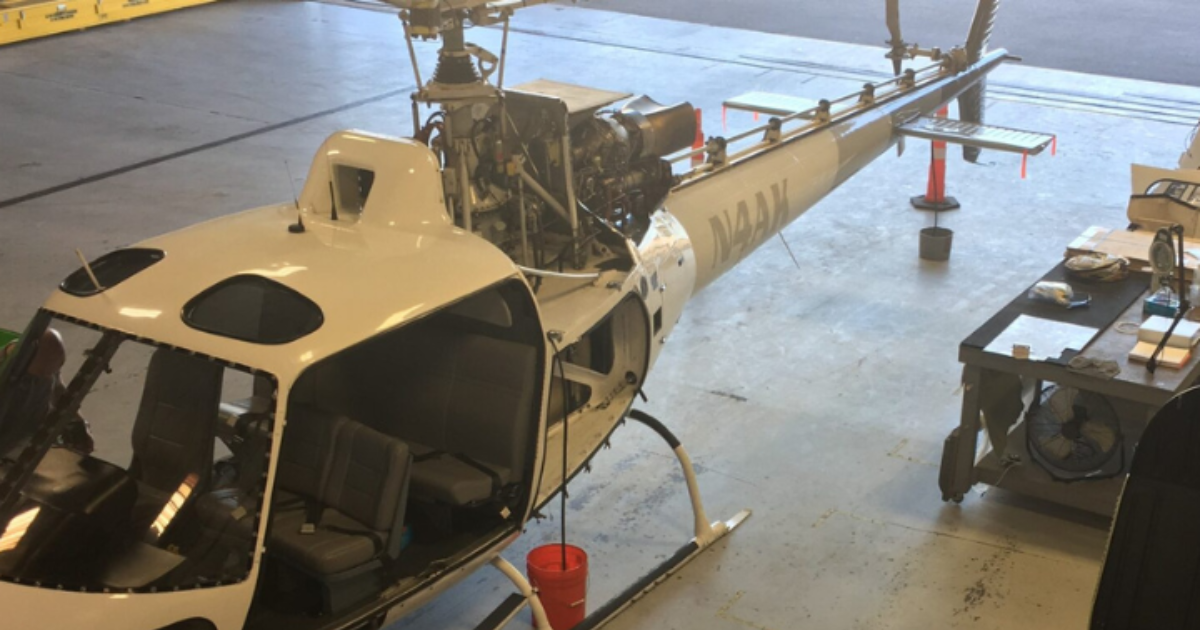 Airbus helicopter with exposed engine and gearbox components during maintenance and inspection for bevel and epicyclic gear repair