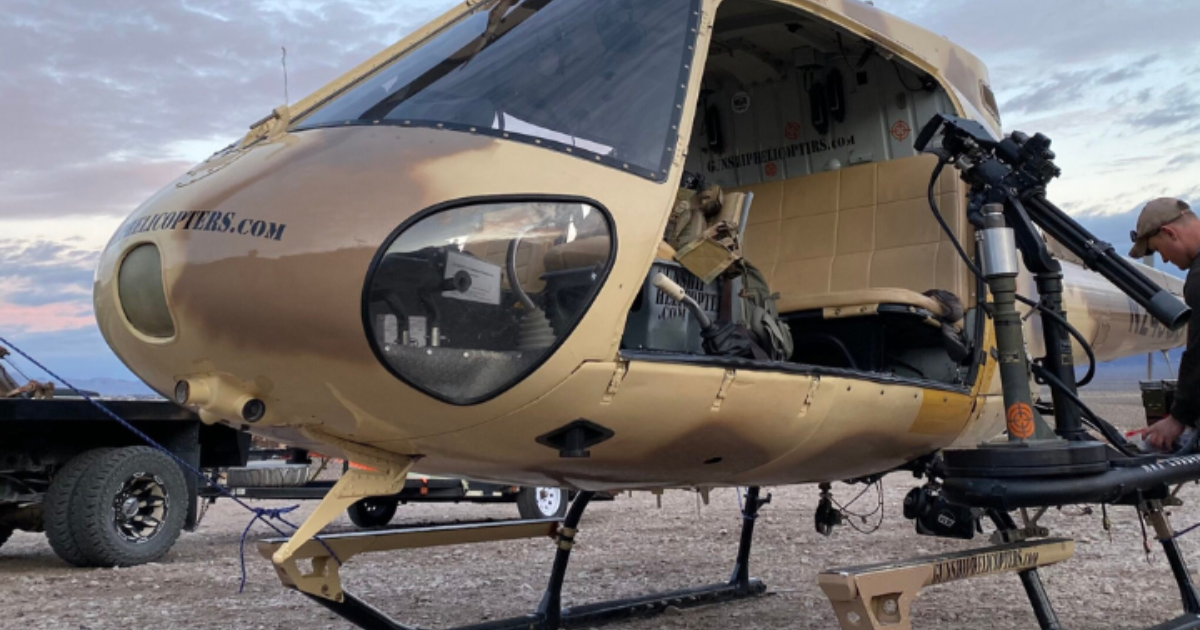 Airbus helicopter undergoing maintenance inspection with focus on tail rotor spider system and helic