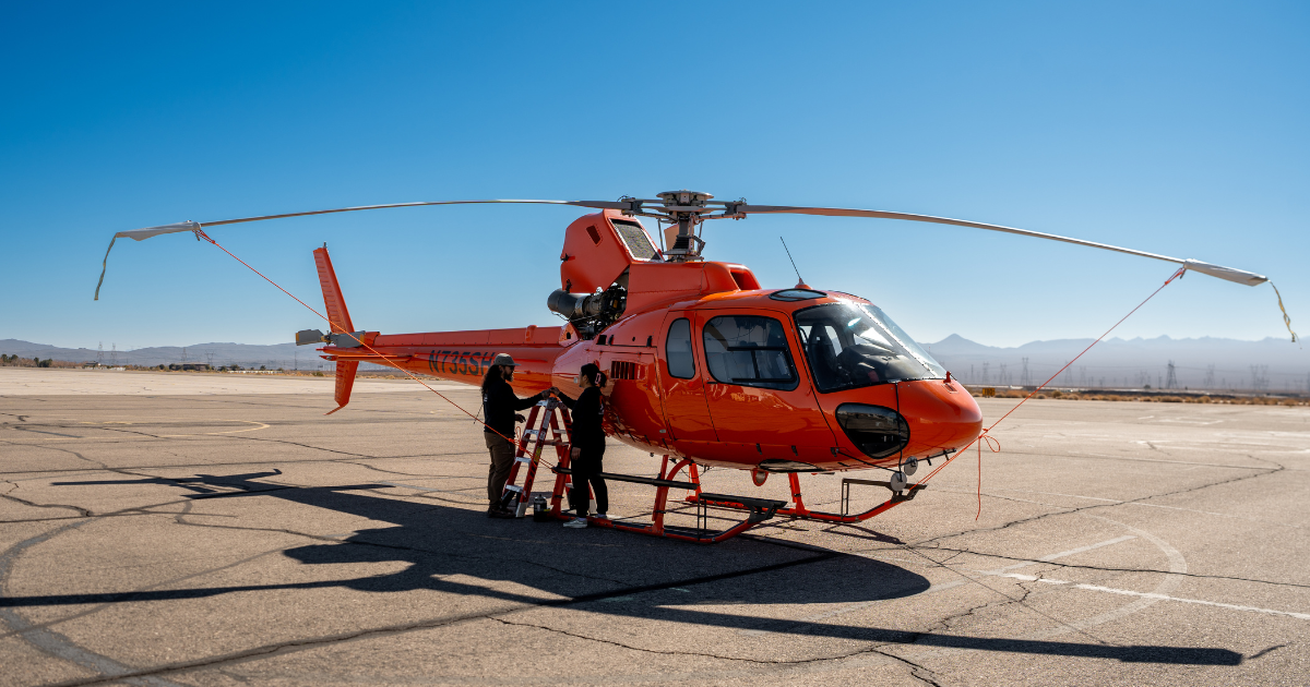 Helicopter maintenance crew servicing Airbus H125 rotorcraft in Boulder City Nevada