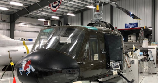 Historic military helicopter on display inside an aviation hangar, illustrating the importance of FA