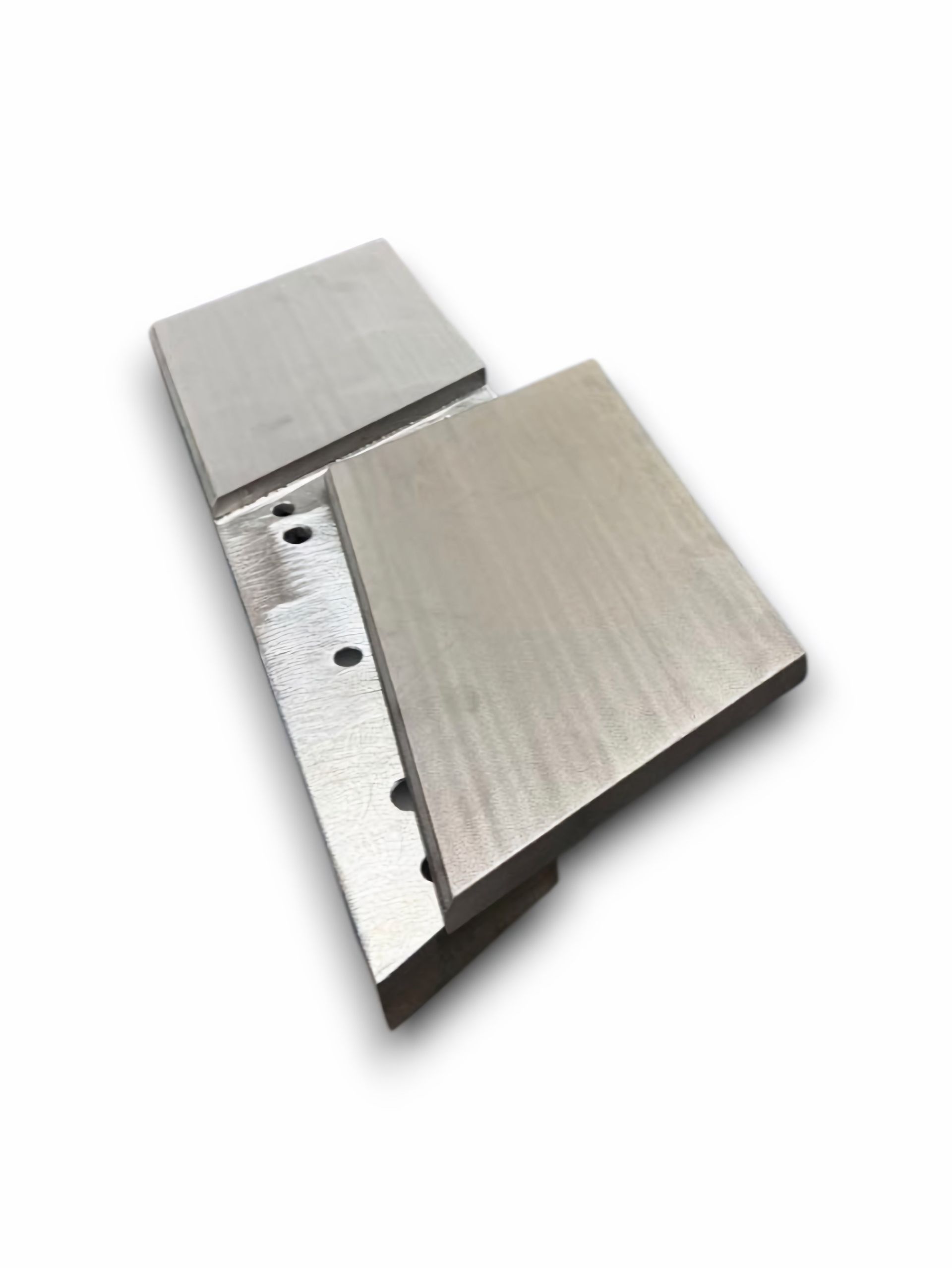 Four black, rectangular, 3D-printed parts; some with holes, others with textured edges, all against white.