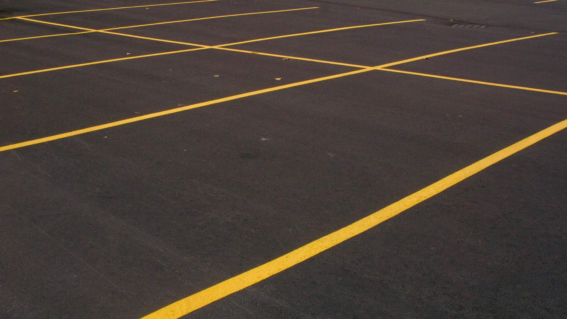 A close up of a parking lot with yellow lines