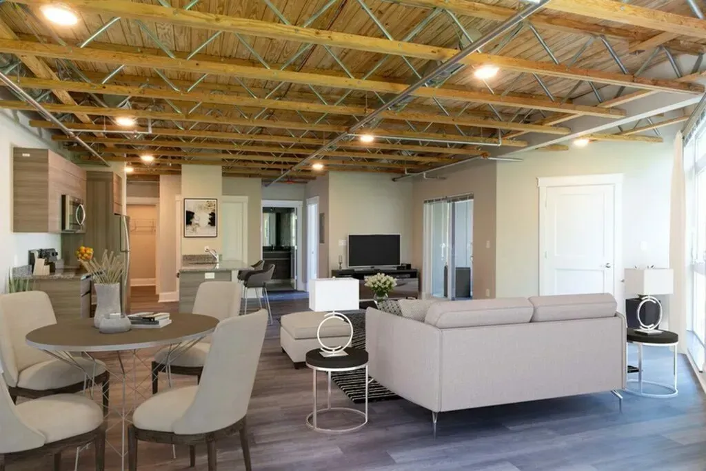 Open-concept living space with exposed ceiling beams, modern furniture, dining area, and television.