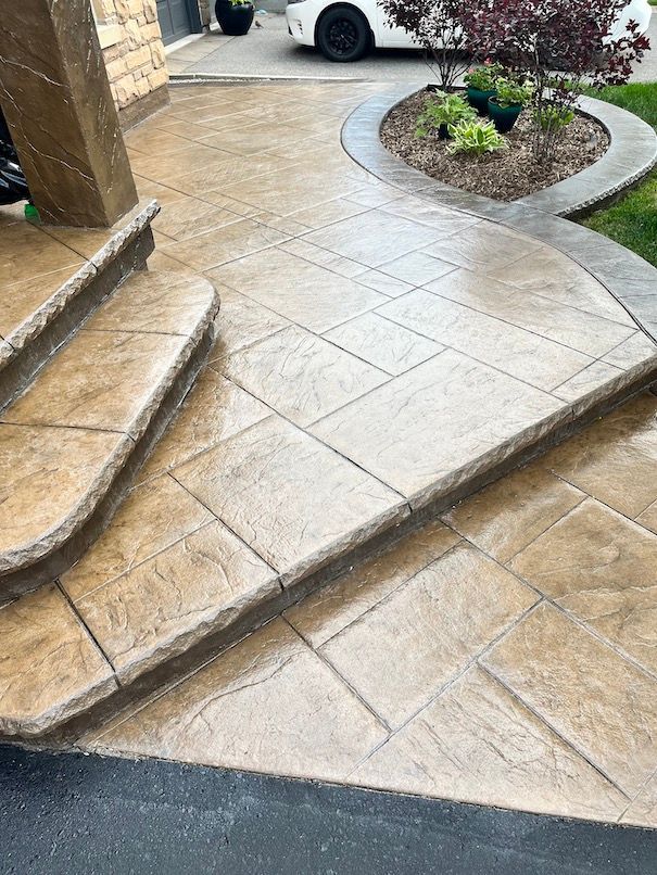 A concrete walkway with stairs and a car parked in the background.