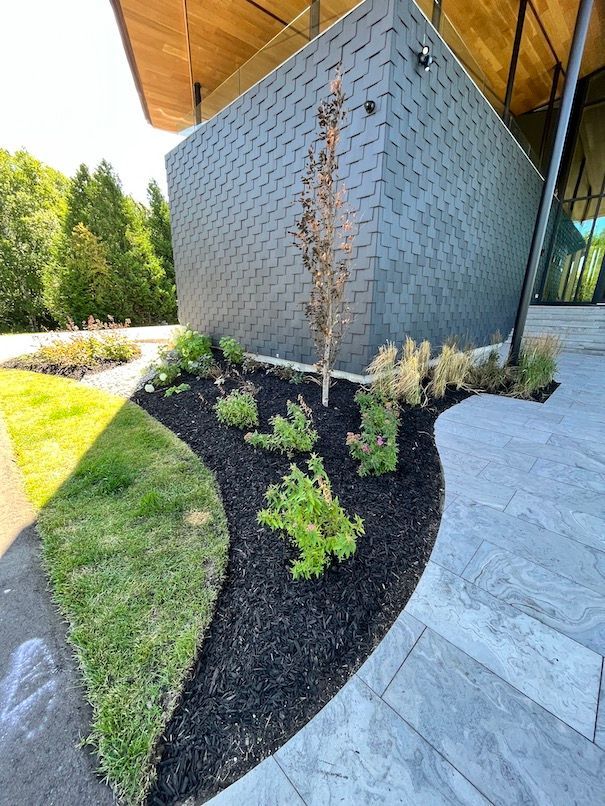 A large building with a lot of plants in front of it.