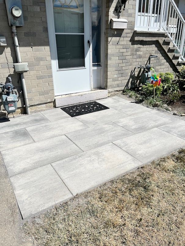 A brick house with a patio in front of it.